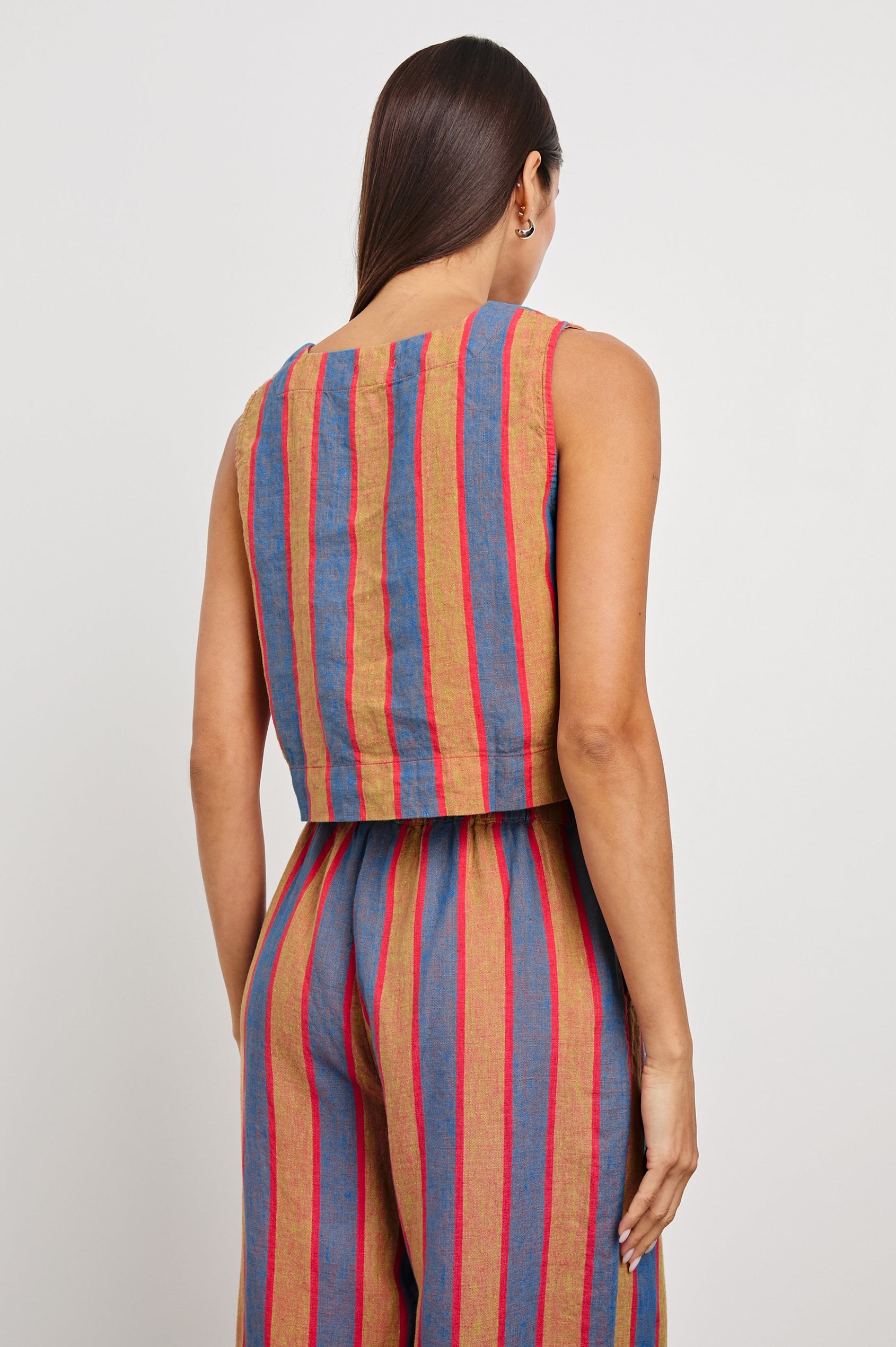 Akira Sleeveless Crop Top with Square Neckline and Wide Shoulder Straps in Rio Stripe Colorway, Vertical Stripes in Tan, Blue, and Pink - Back View Featured on Model