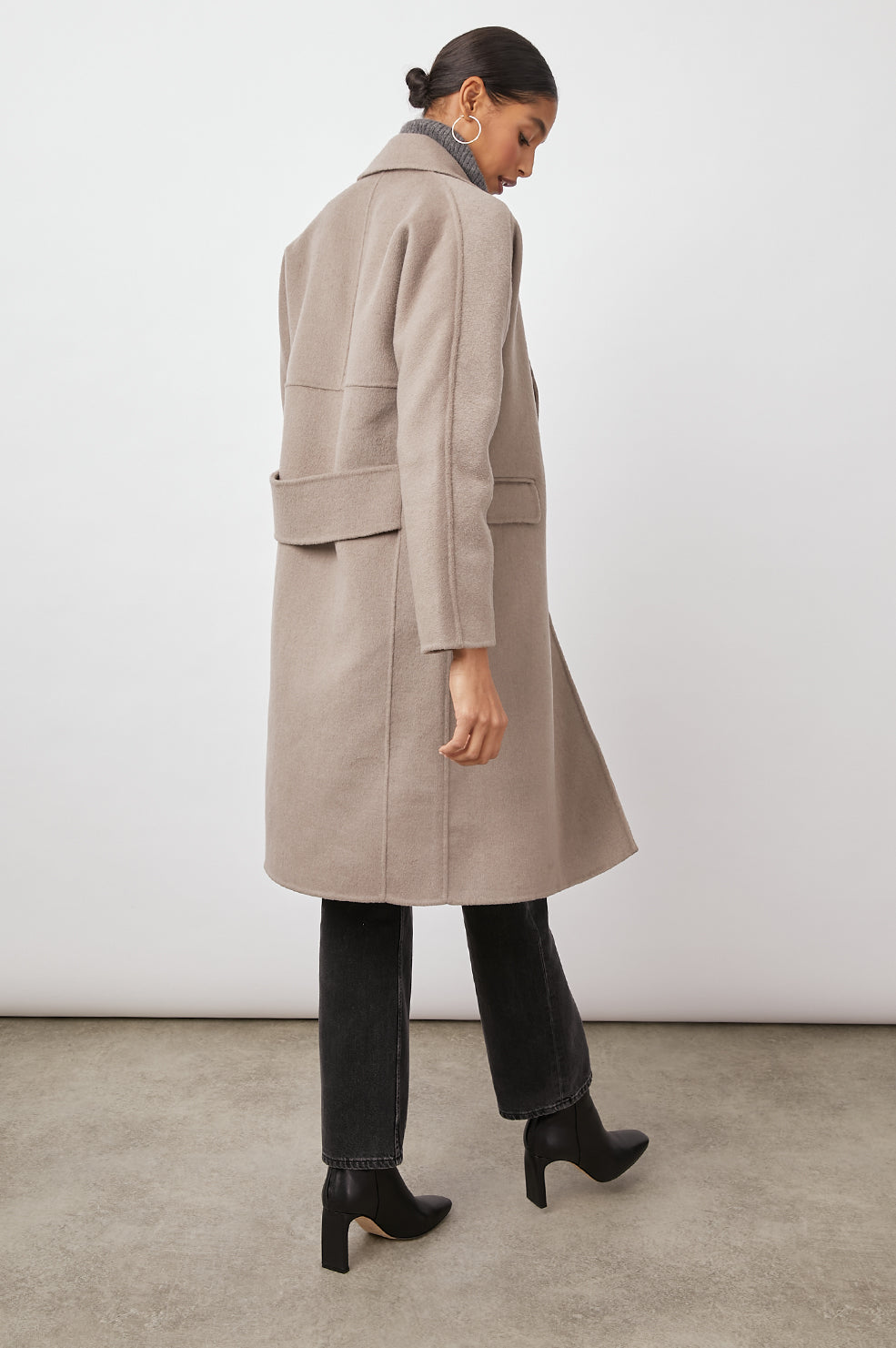 Bristol Knee-Length Double Breasted Coat with Two-Button Closure, Notched Lapels, Two Front Flap Pockets, Center Back Seams, and a Belted Back in Mink Colorway, a Light Brown - Back Full View Featured on Model