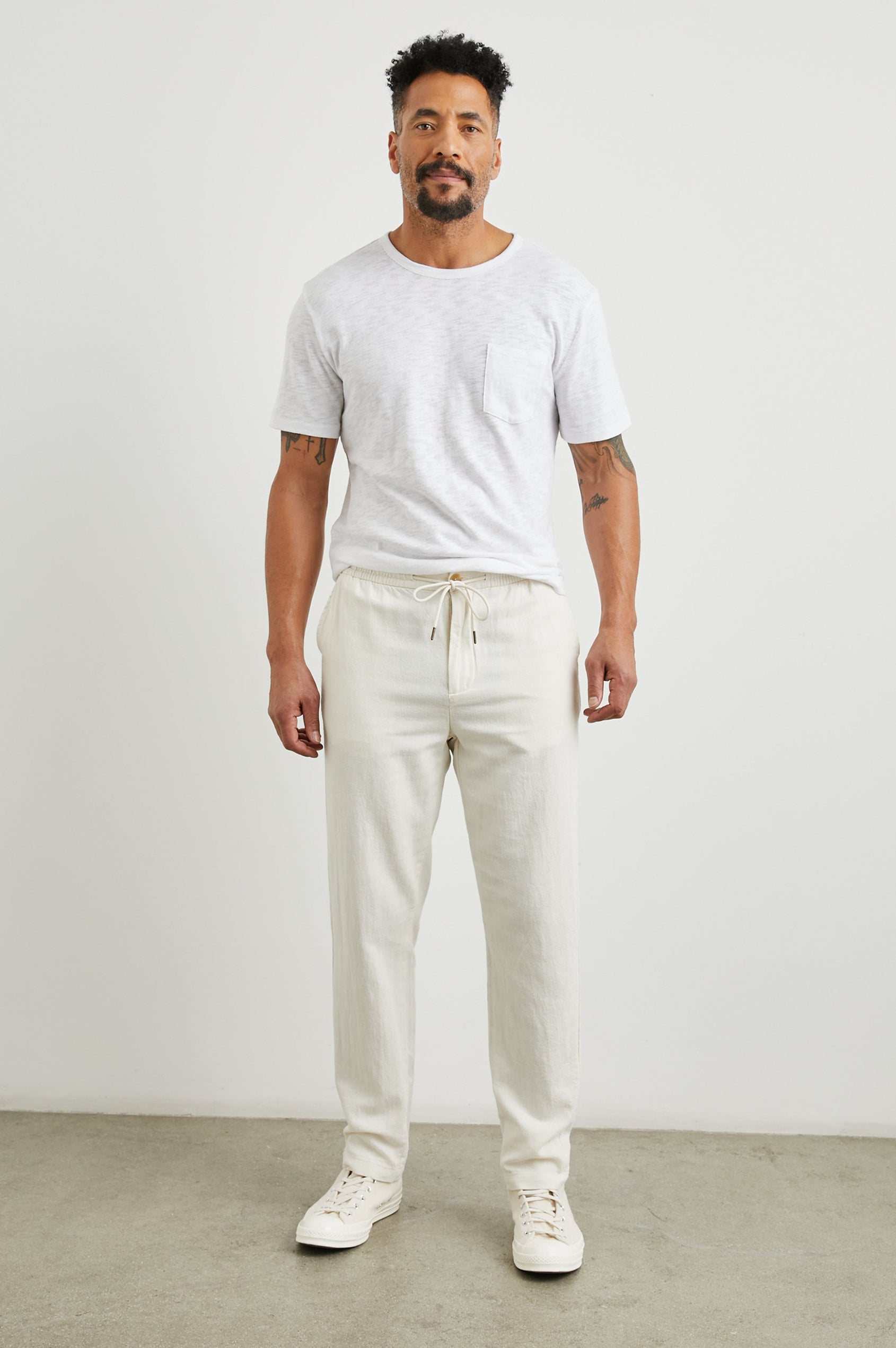 Callum Pants with a Drawstring Waist, Two Front Pockets and a Back Patch Pocket in Ecru Colorway - Front Full Body View Featured on Model