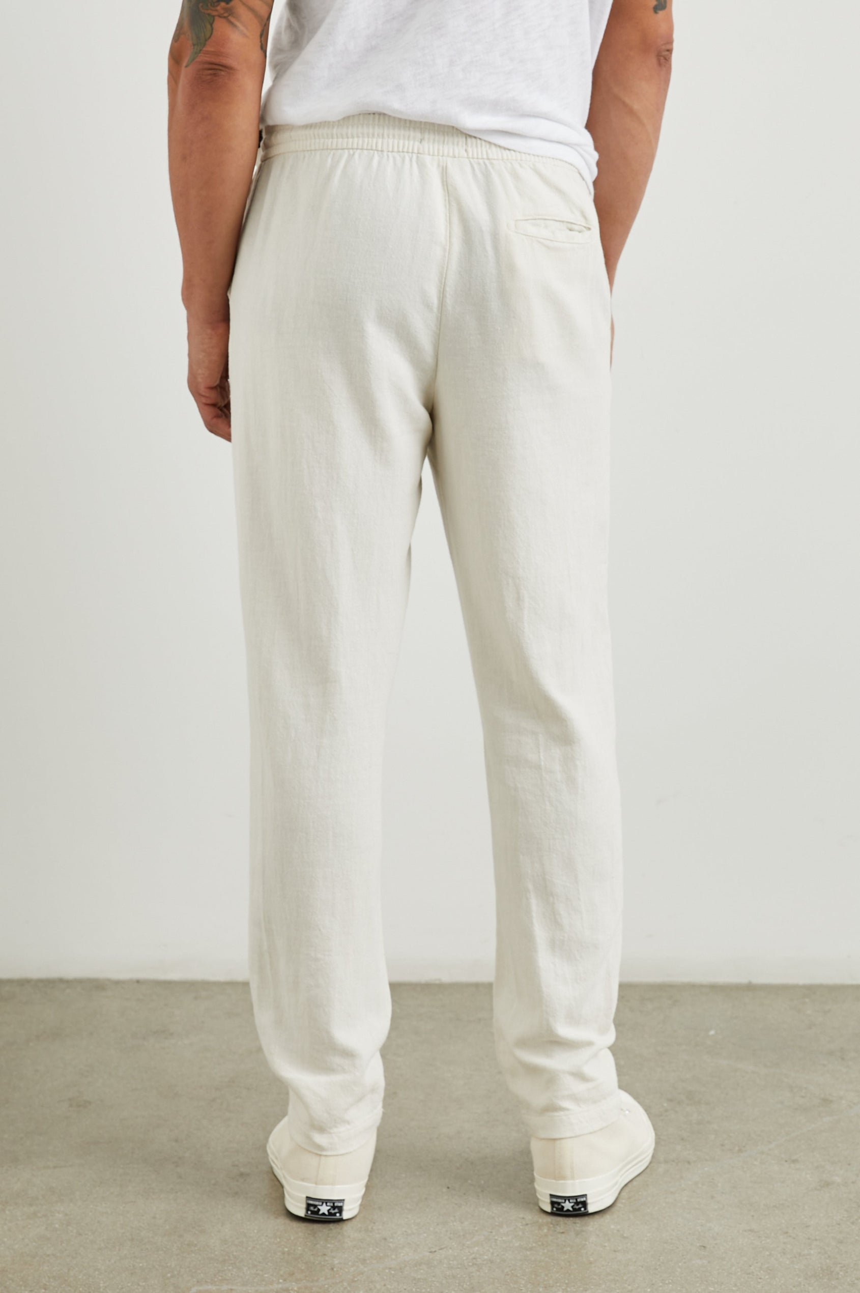 Callum Pants with a Drawstring Waist, Two Front Pockets and a Back Patch Pocket in Ecru Colorway - Back View Featured on Model
