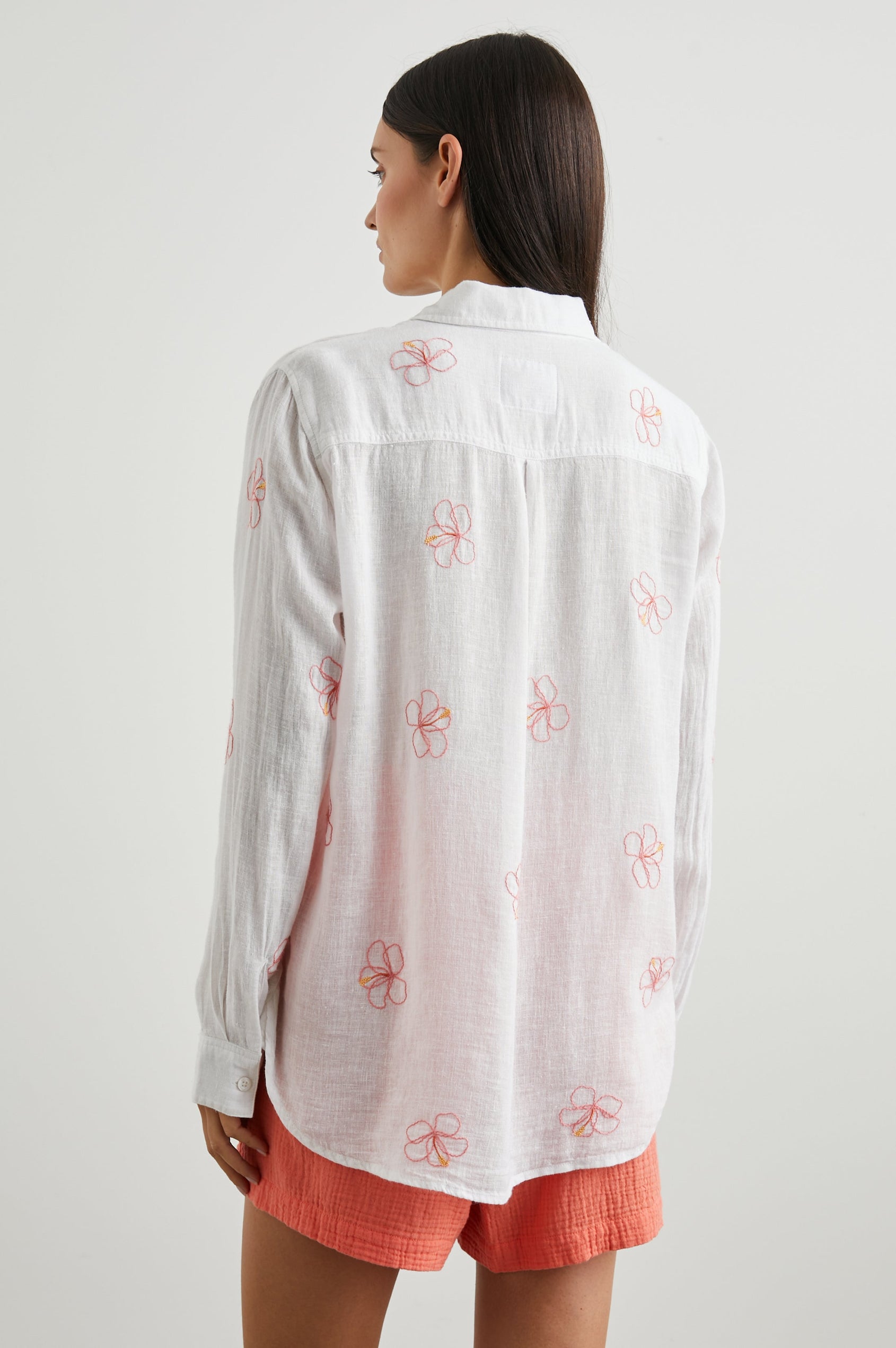 Charli Long-Sleeve Button up with a Chest Patch Pocket in Hibiscus Embroidery Colorway, with Hibiscus on white - Back View Featured on Model