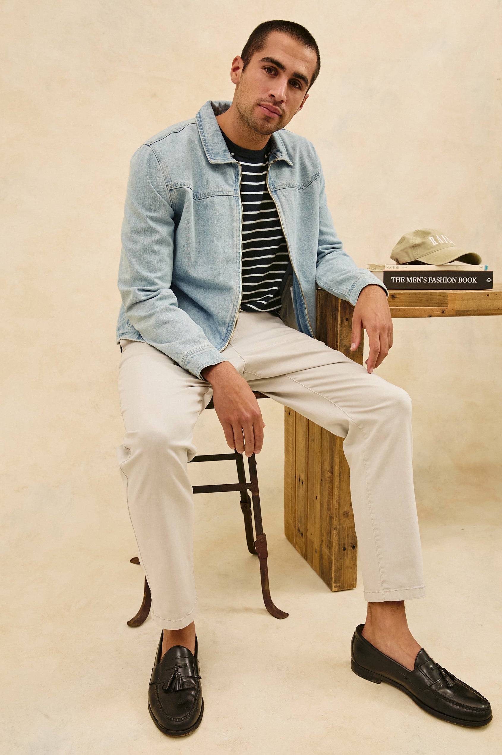 Cooke western style zip-up jacket with contrast stitching details in Light Wash - stylized view on model, sitting down