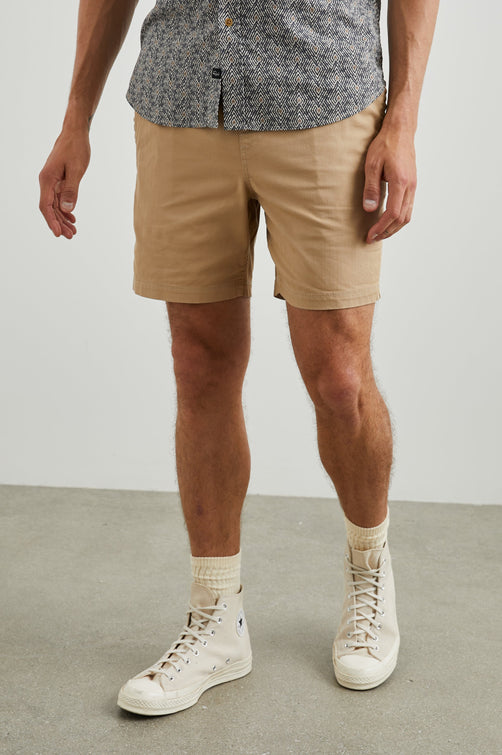 Cruz Shorts with a Drawstring Waist, Two Front Pockets, Two Back Button Flap Pockets in Khaki Colorway - Front View Featured on Model