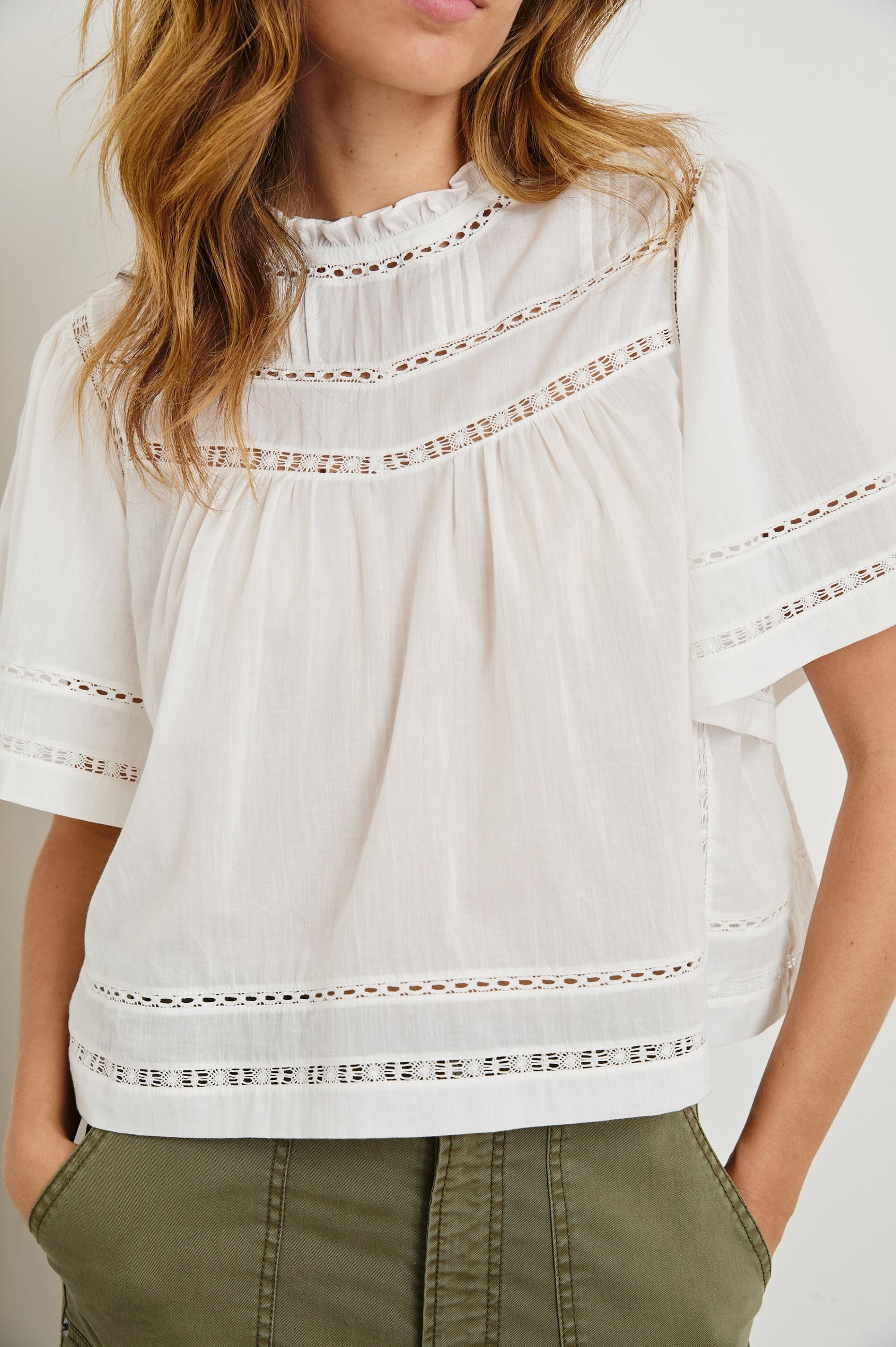 Daisy Short Sleeve Top with Shirred Collar, Trimmed with Cutouts, Keyhole with button in back in White Colorway - Front View Featured on Model