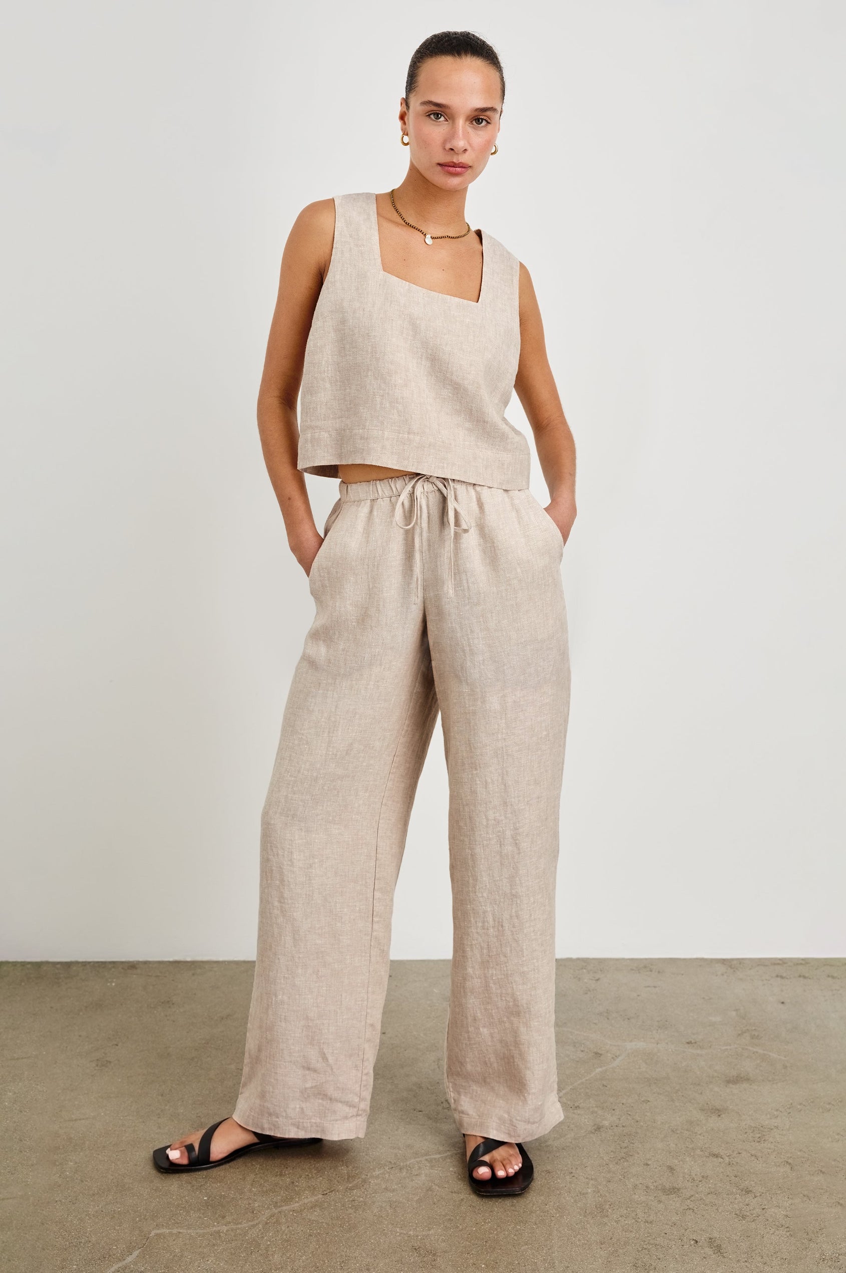 Emmie high rise linen wide leg pant with drawstring and Akira relaxed fit linen crop top with wide straps in Heathered Flax - full body front view on model