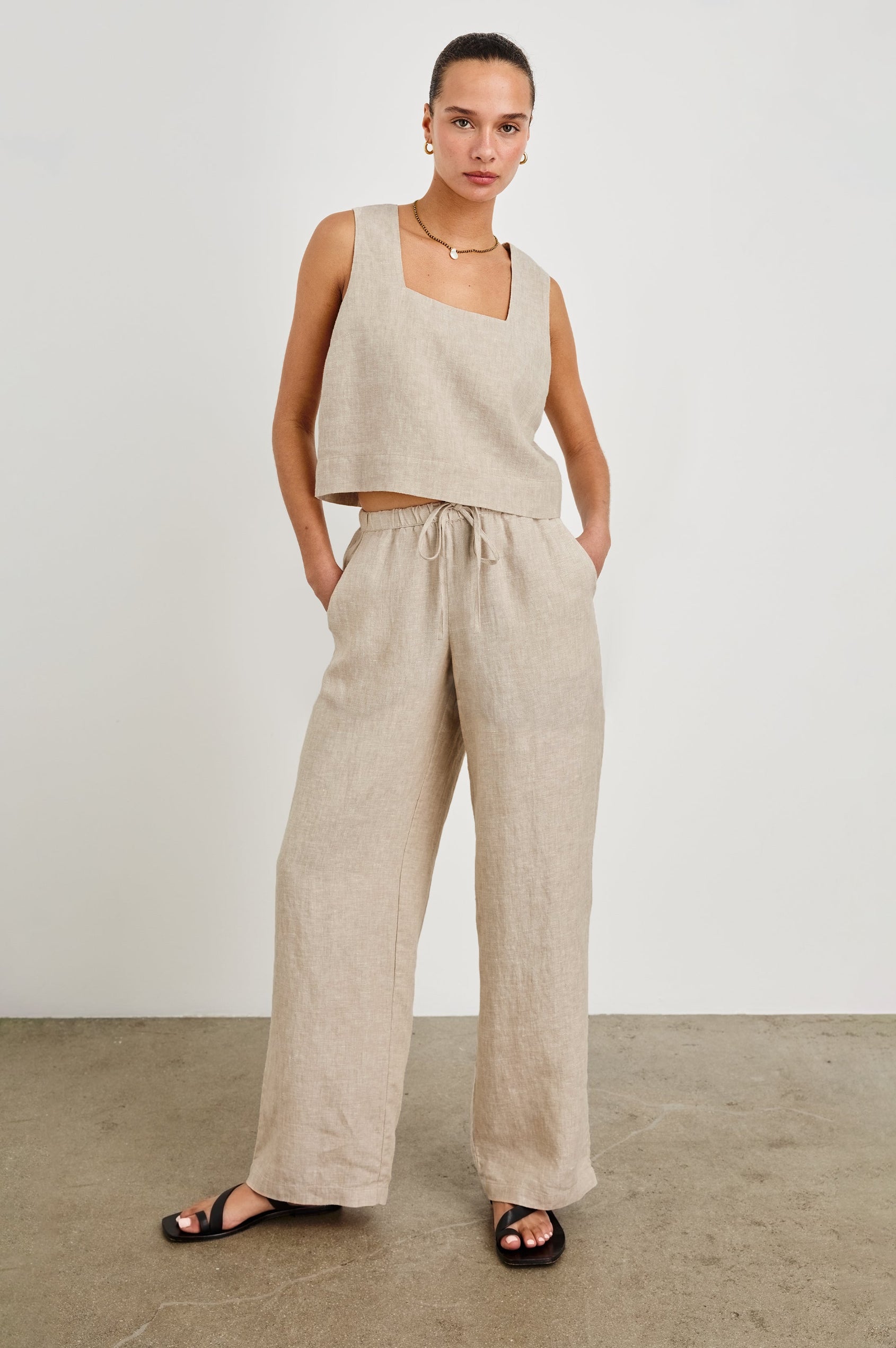 Emmie high rise linen wide leg pant with drawstring and Akira relaxed fit linen crop top with wide straps in Heathered Flax - full body front view on model