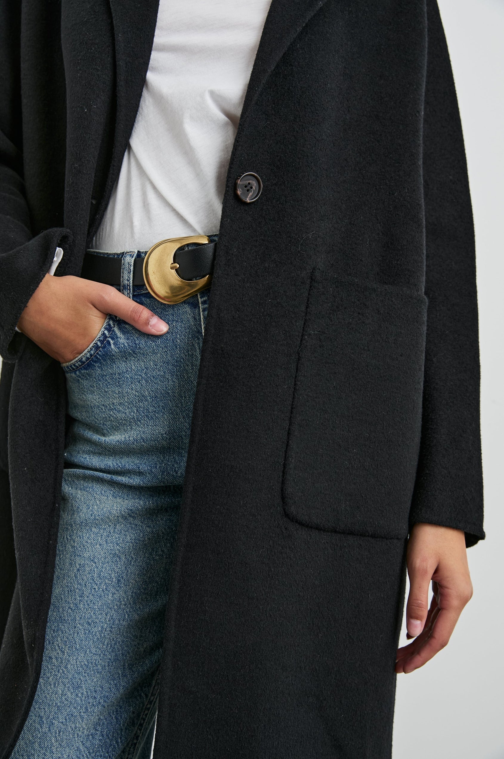 Everest Mid-Thigh Length Coat with Single Button Closure, Notched Lapels and Front Patch Pockets in Black Colorway - Front View Featured on Model