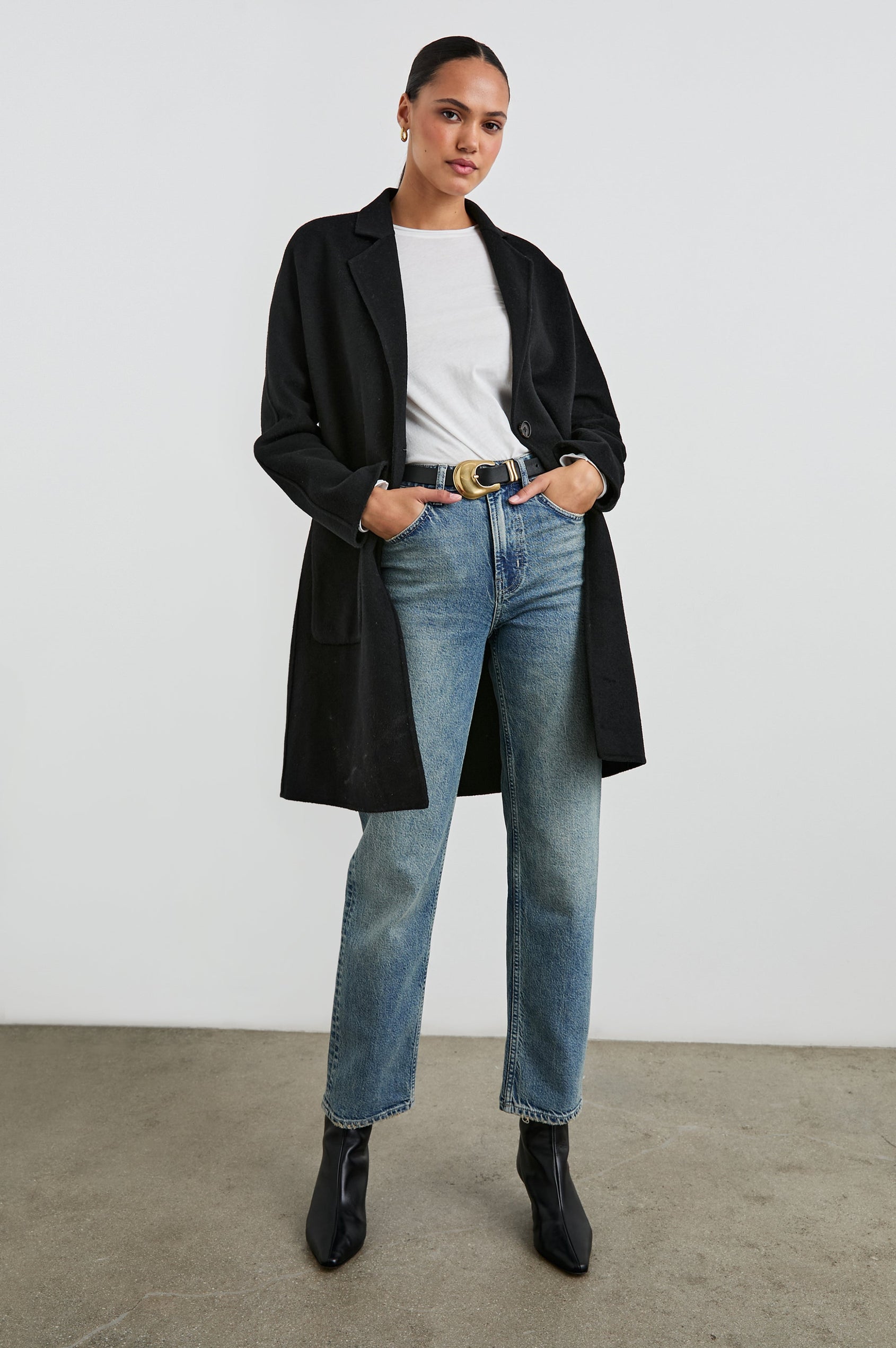 Everest Mid-Thigh Length Coat with Single Button Closure, Notched Lapels and Front Patch Pockets in Black Colorway - Front Full Body View Featured on Model