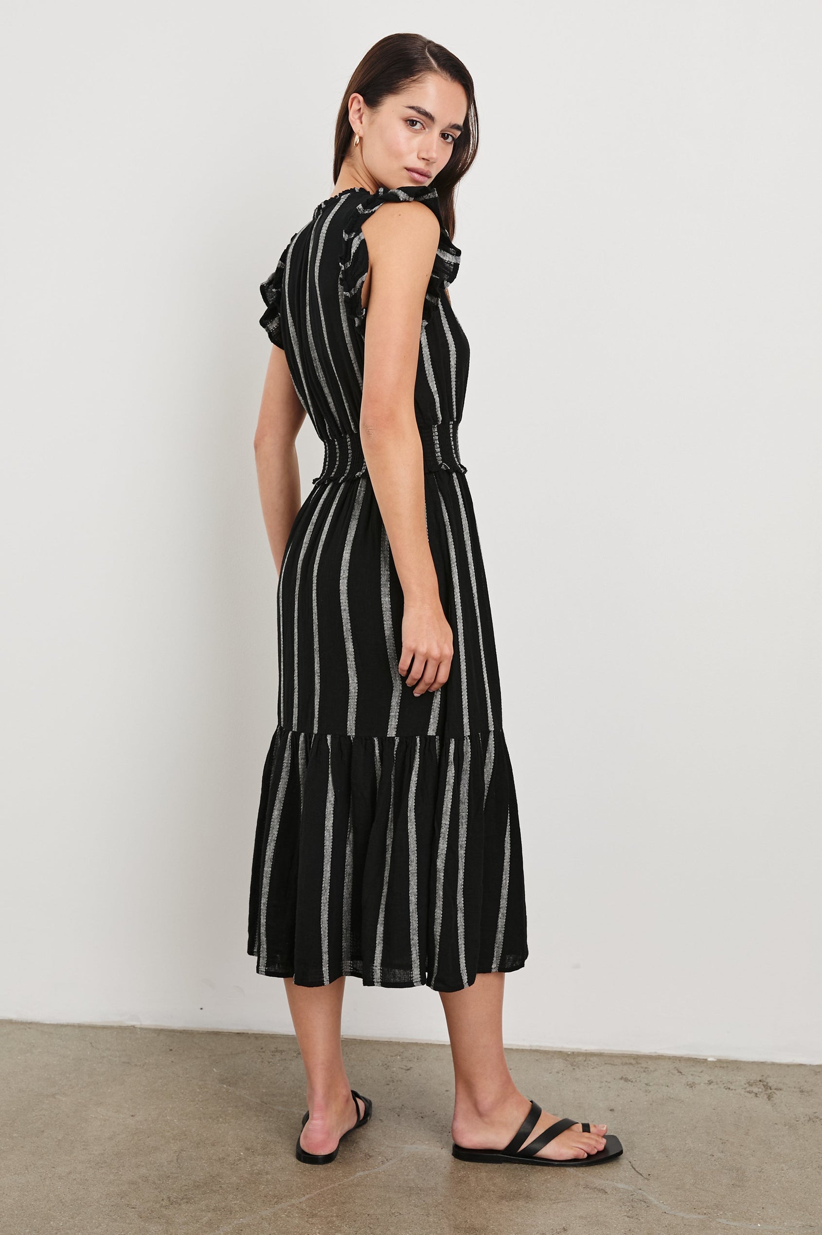 Garden Midi Dress with Flutter Cap Sleeves, Drawstrings at V-Neck and Shirred Waistband in Ash Leno Stripe Colorway, with Grey Vertical Stripes on Black - Back Full Body View Featured on Model