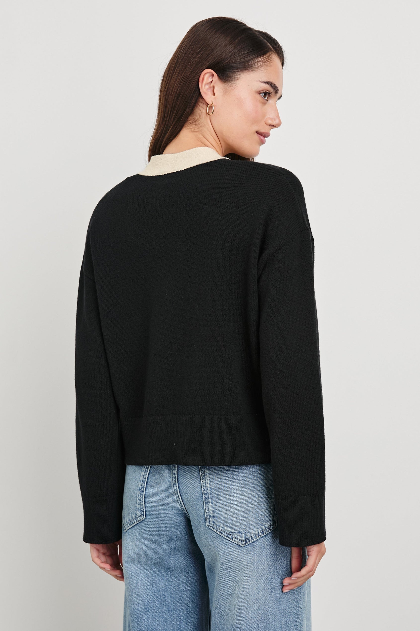 Geneva Long-Sleeve Cardigan with Two Front Patch Pockets and Button Closure in Black Ivory Colorway, with Ivory neckline, closure and pocket openings on Black - Back View Featured on Model