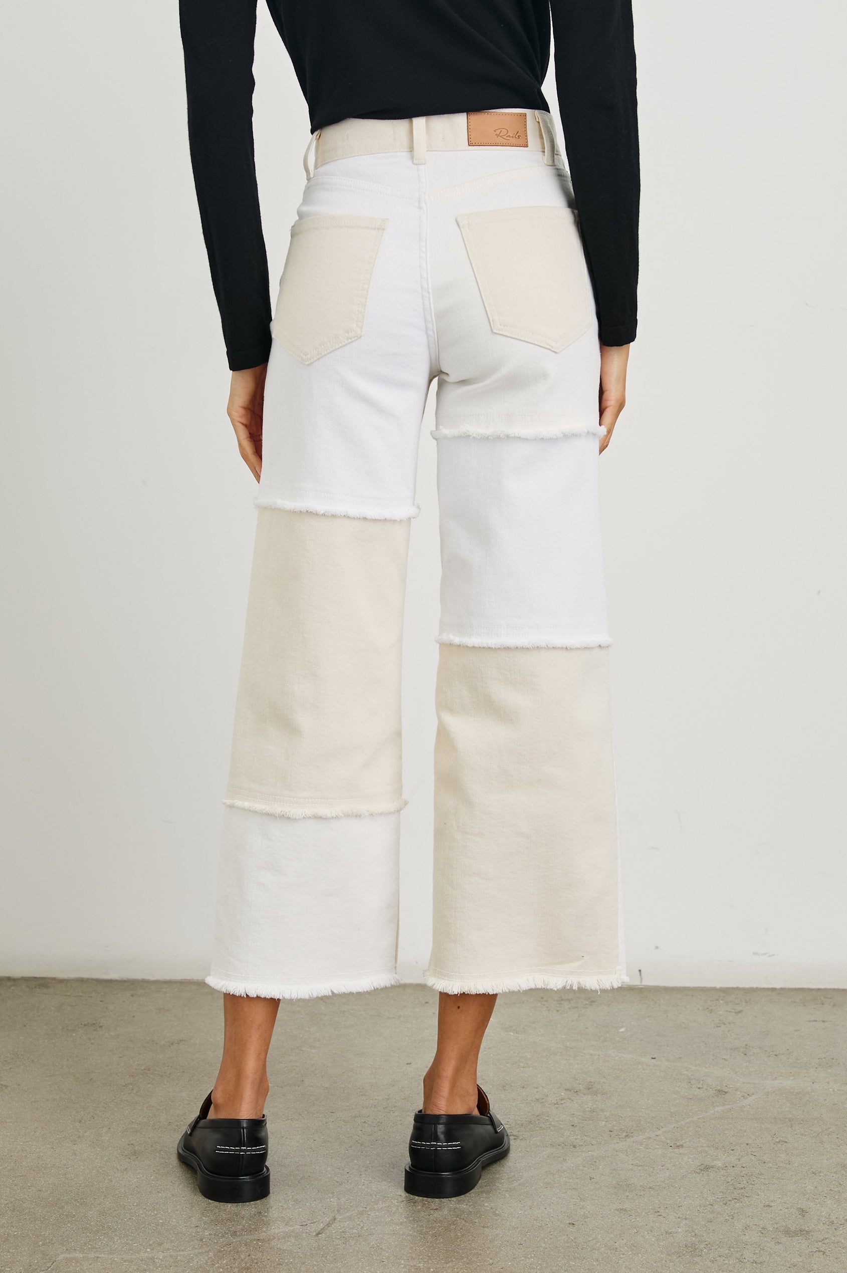 Getty Crop Wide Leg Denim Pants with Belt Loops, Two Front Pockets and Two Back Patch Pockets in Ecru Patchwork Colorway, with large patches in shades of white - Back View Featured on Model