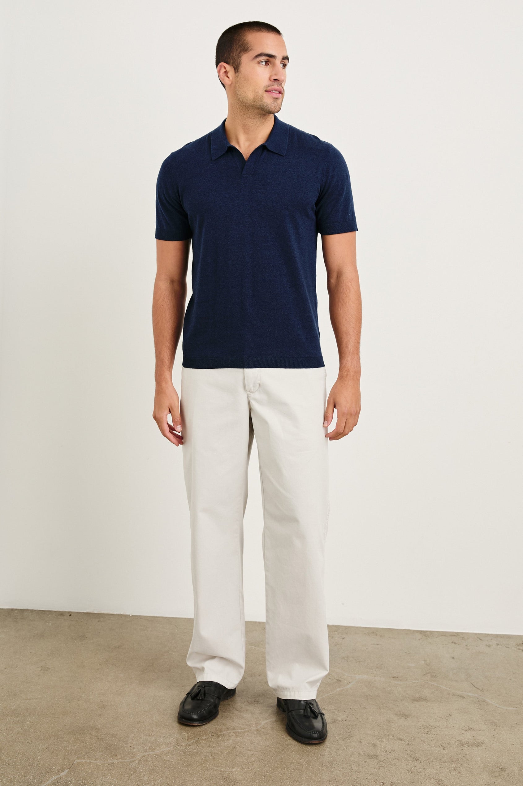 Hayden cotton short sleeve polo with collar and short placket in Navy - full body front view on model