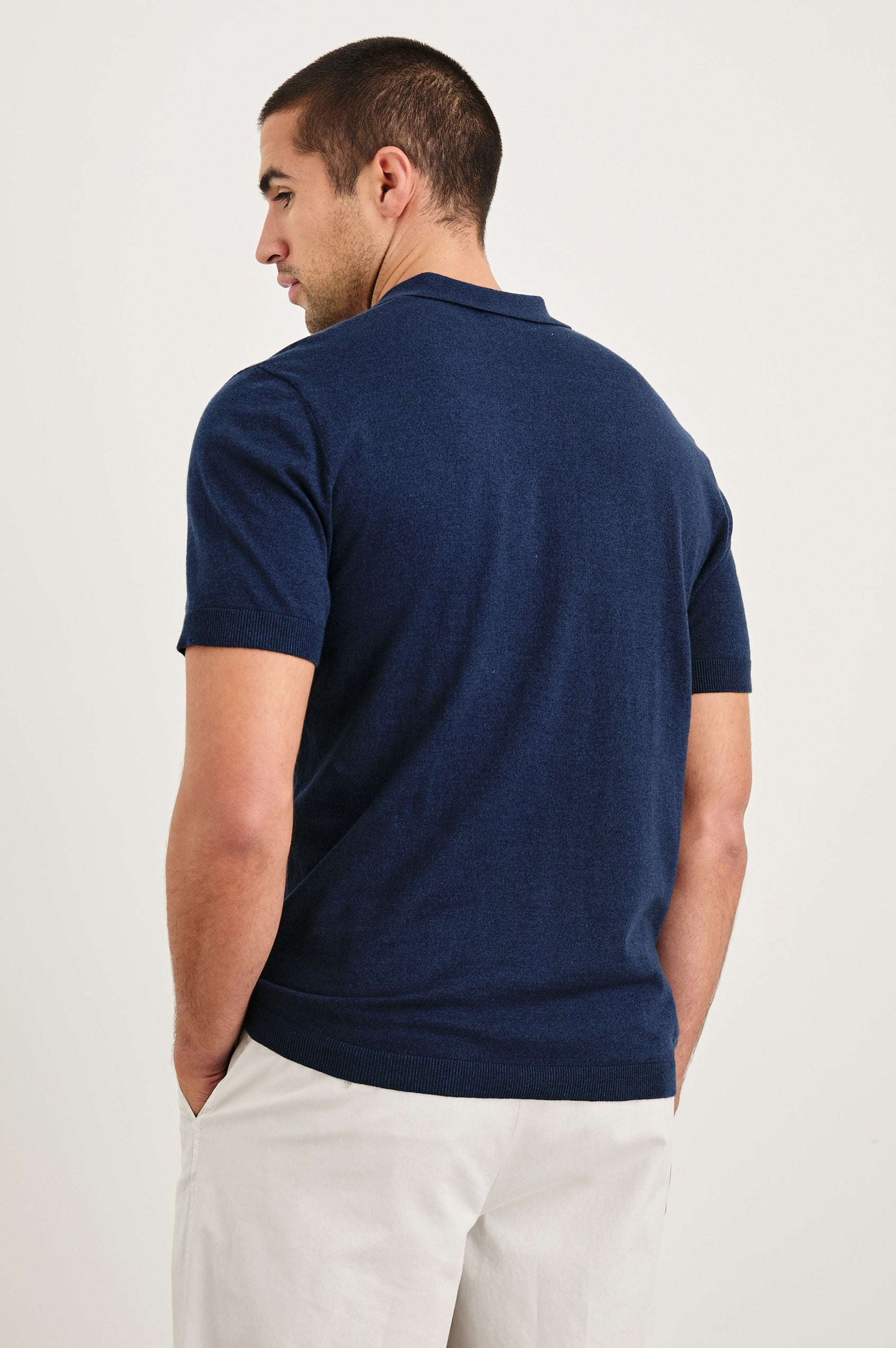 Hayden cotton short sleeve polo with collar and short placket in Navy - back view on model