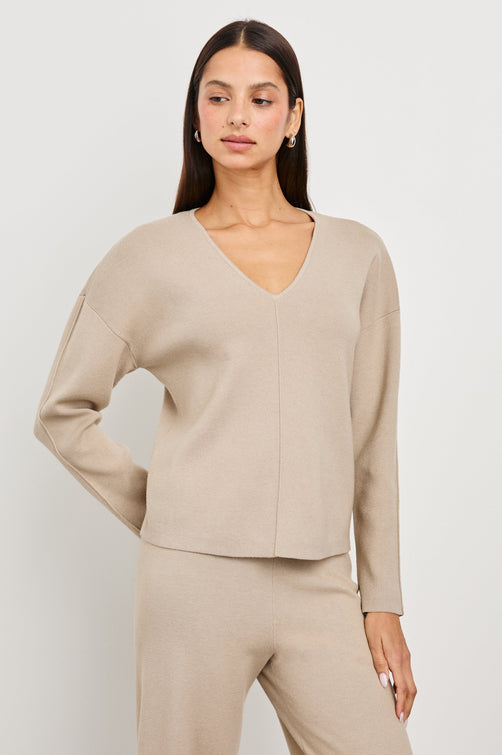 Hollyn Long-Sleeve, V Neck Sweater with a Vertical Seam Down the Front Bodice in Oatmeal Colorway - Front View Featured on Model