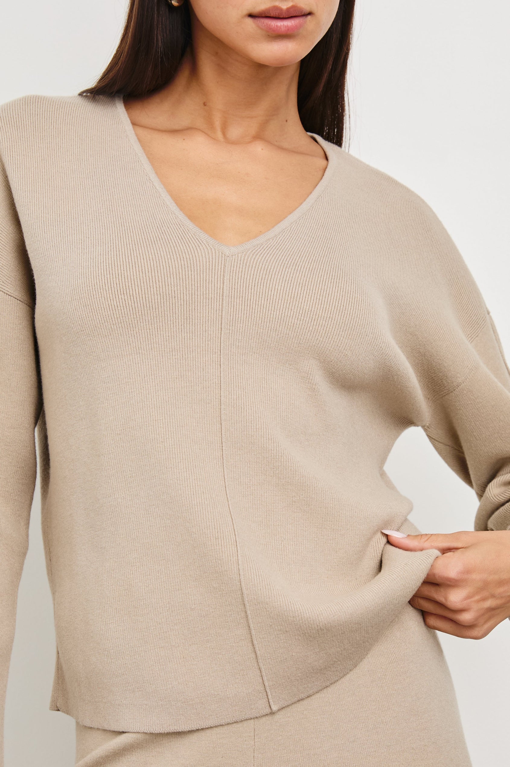 Hollyn Long-Sleeve, V Neck Sweater with a Vertical Seam Down the Front Bodice in Oatmeal Colorway - Front View Featured on Model