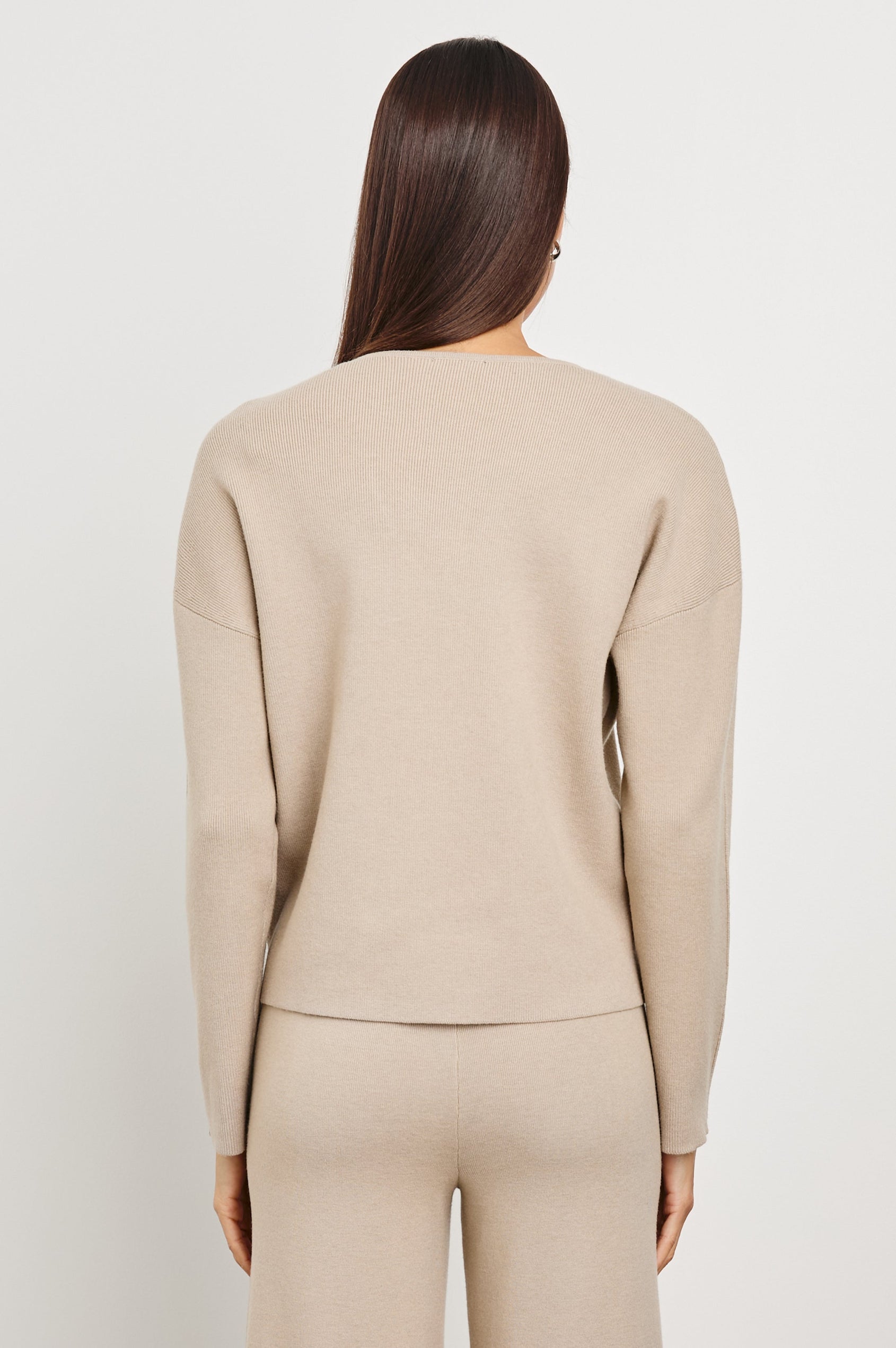 Hollyn Long-Sleeve, V Neck Sweater with a Vertical Seam Down the Front Bodice in Oatmeal Colorway - Back View Featured on Model