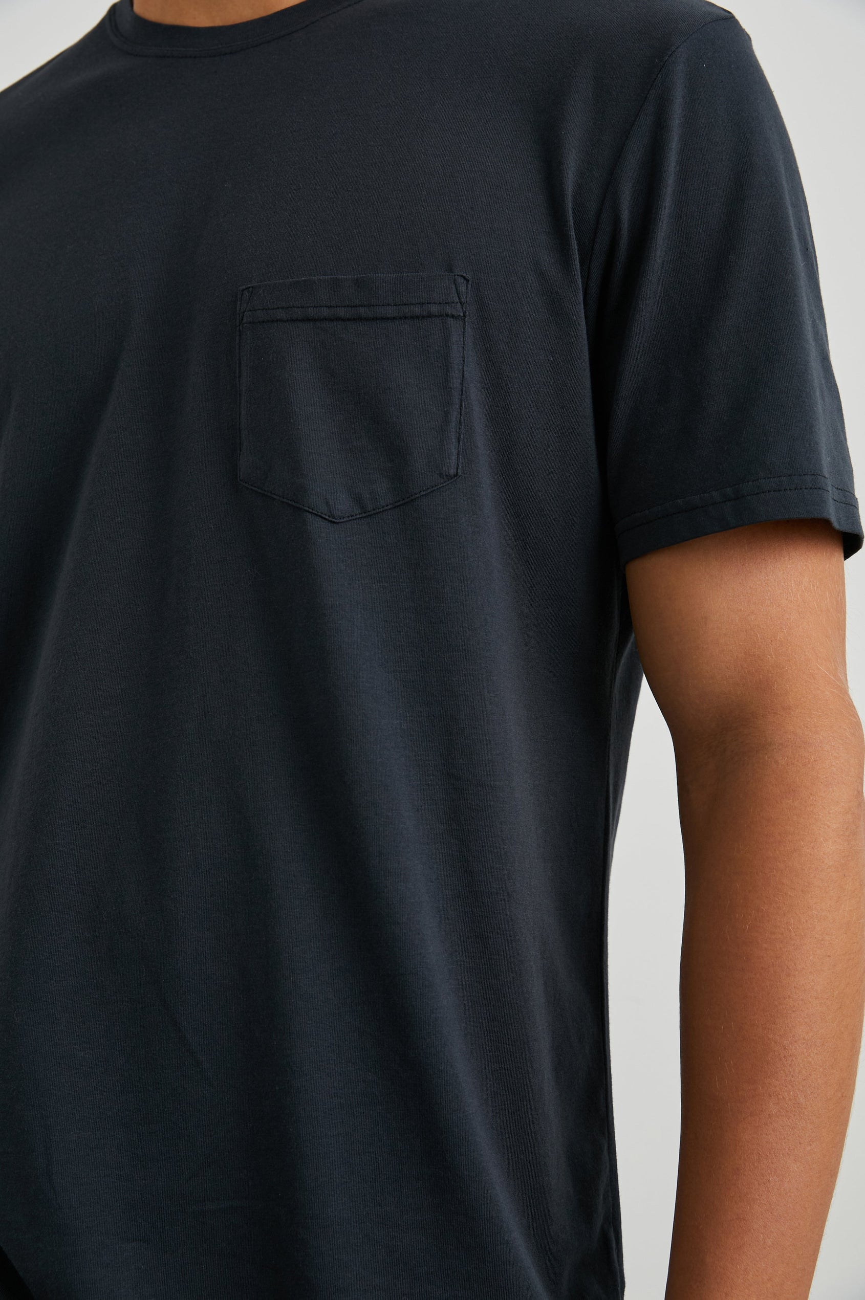 Johnny Short Sleeve T-Shirt with a Crew Neck, Chest Patch Pocket and Small Slits at the Side Hems in Carbon Colorway - Front View Featured on Model