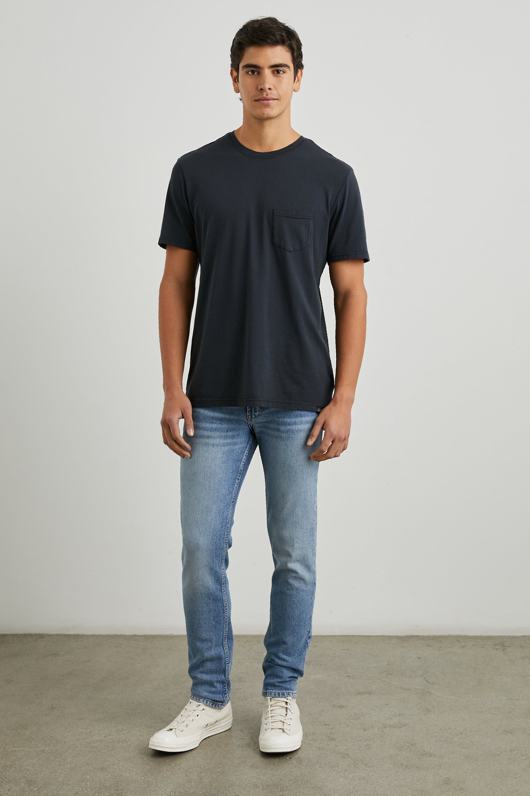 Johnny Short Sleeve T-Shirt with a Crew Neck, Chest Patch Pocket and Small Slits at the Side Hems in Carbon Colorway - Front Full Body View Featured on Model
