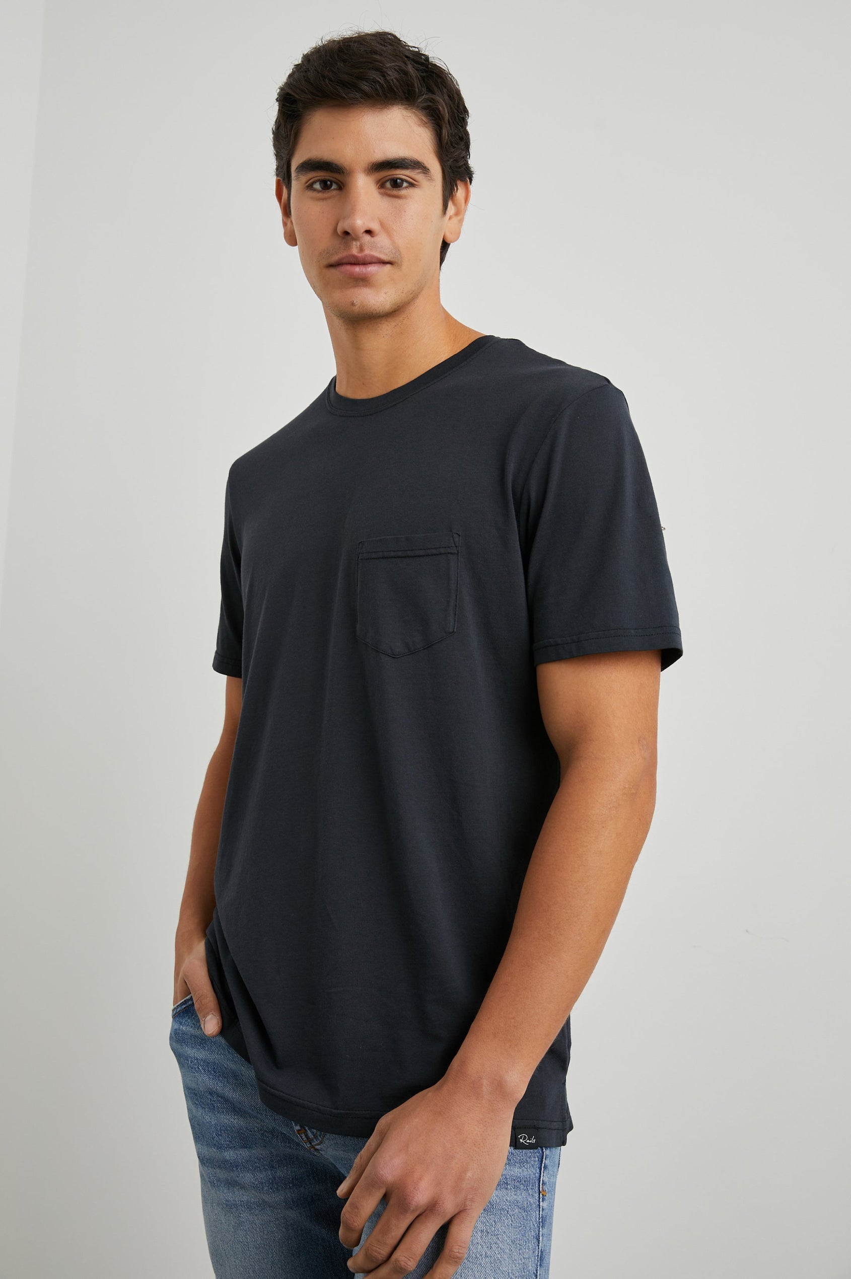 Johnny Short Sleeve T-Shirt with a Crew Neck, Chest Patch Pocket and Small Slits at the Side Hems in Carbon Colorway - Front View Featured on Model