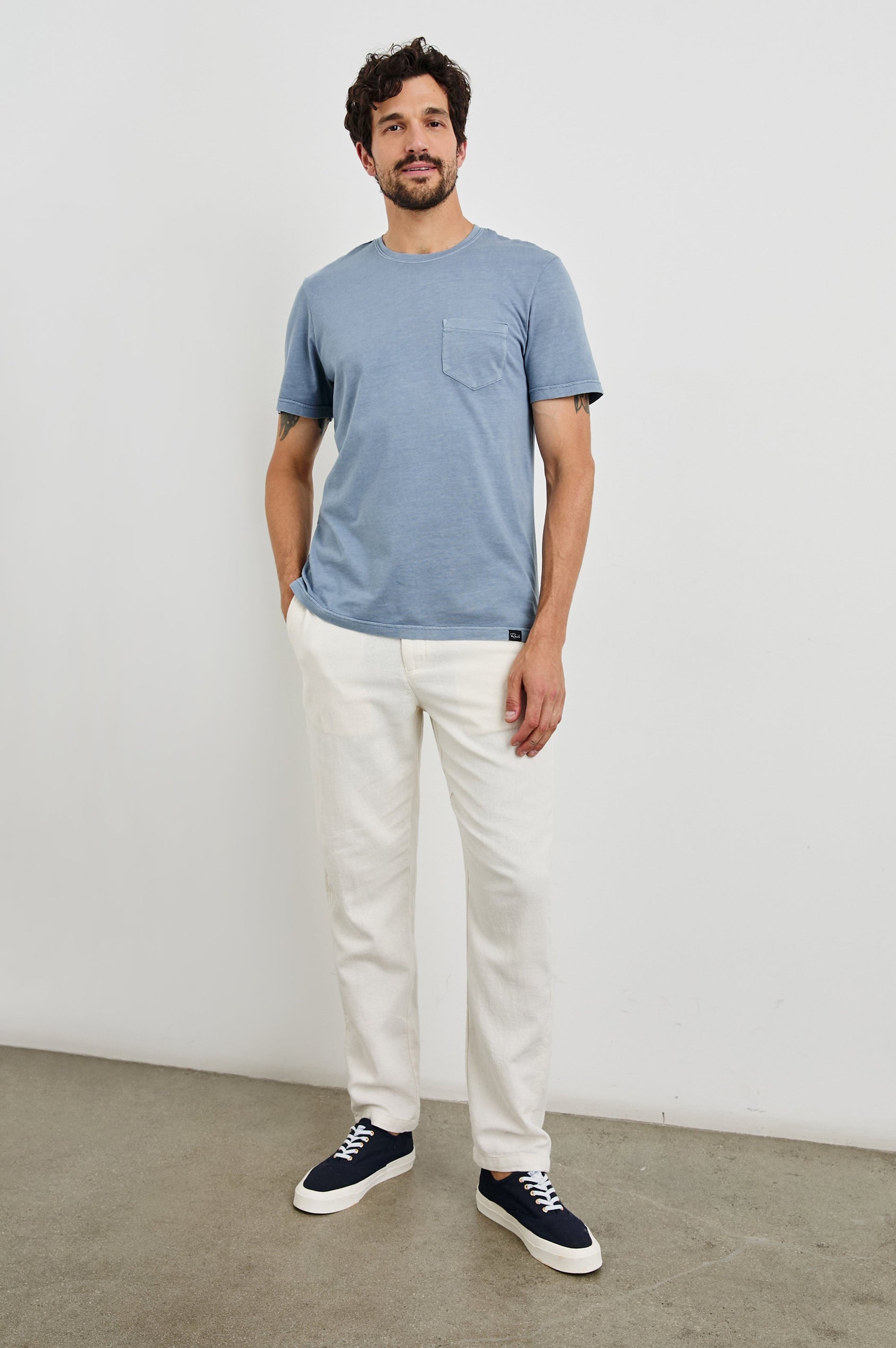 Johnny Short Sleeve T-Shirt with a Crew Neck, Chest Patch Pocket and Small Slits at the Side Hems in Steel Colorway - Front Full Body View Featured on Model