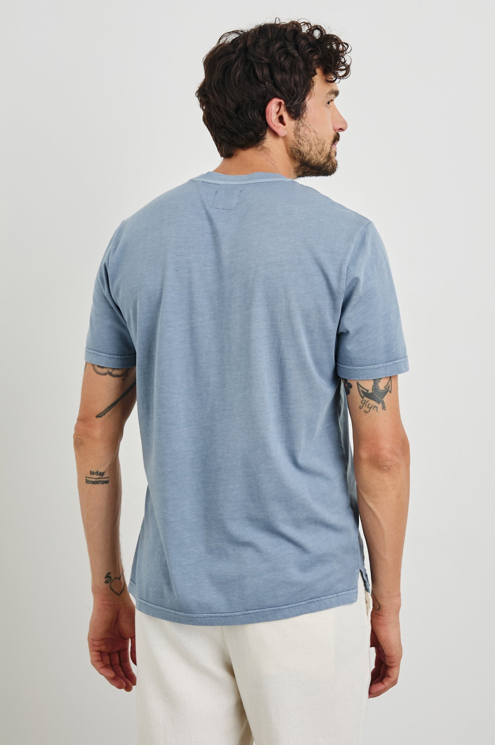 Johnny Short Sleeve T-Shirt with a Crew Neck, Chest Patch Pocket and Small Slits at the Side Hems in Steel Colorway - Back View Featured on Model