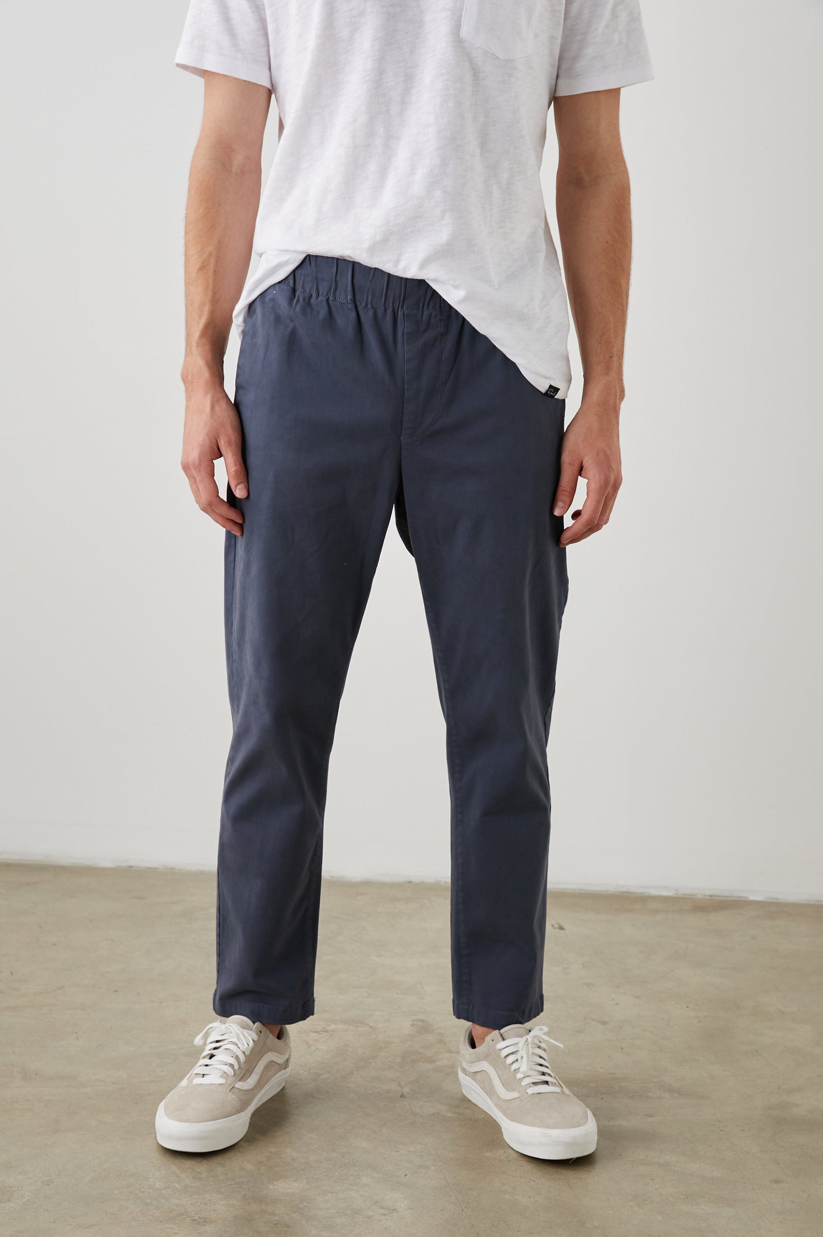 Julian Pants with an Elastic Waist, Two Front Pockets and Two Back Welt Pockets in Faded Blue Colorway - Front View Featured on Model