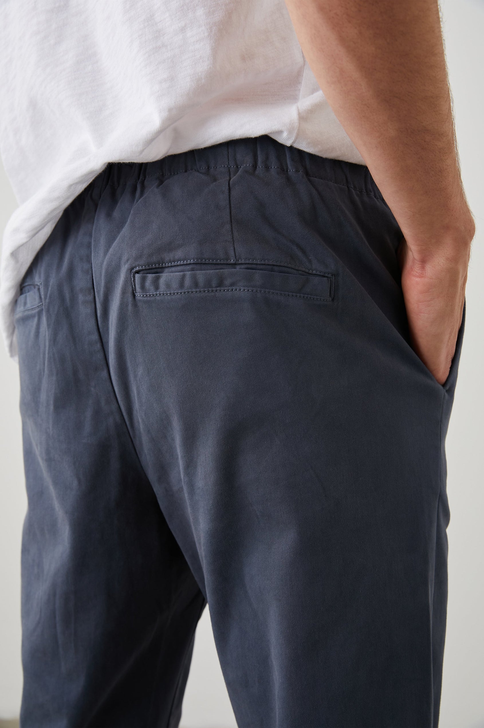 Julian Pants with an Elastic Waist, Two Front Pockets and Two Back Welt Pockets in Faded Blue Colorway - Back View Featured on Model