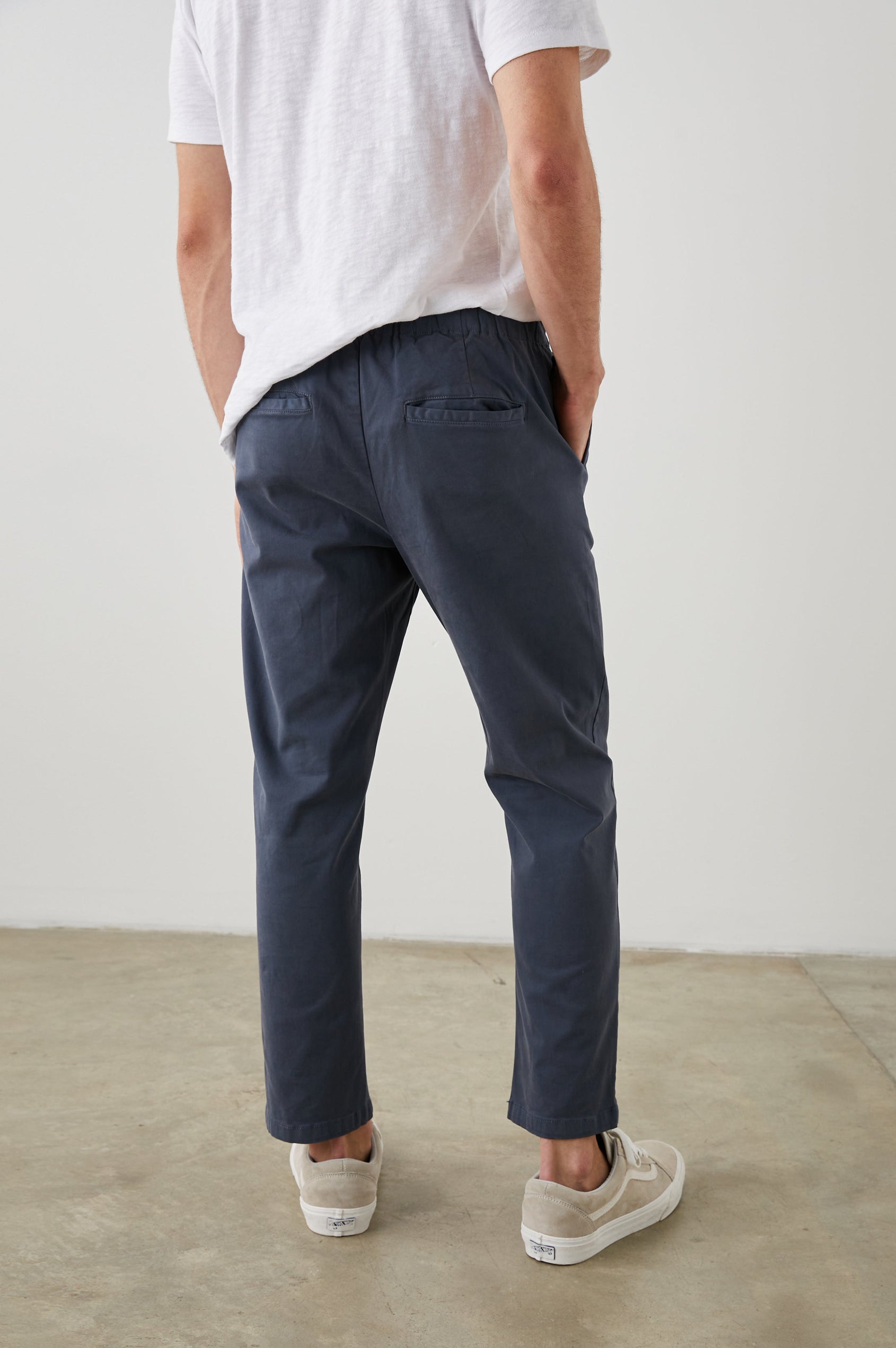 Julian Pants with an Elastic Waist, Two Front Pockets and Two Back Welt Pockets in Faded Blue Colorway - Back View Featured on Model