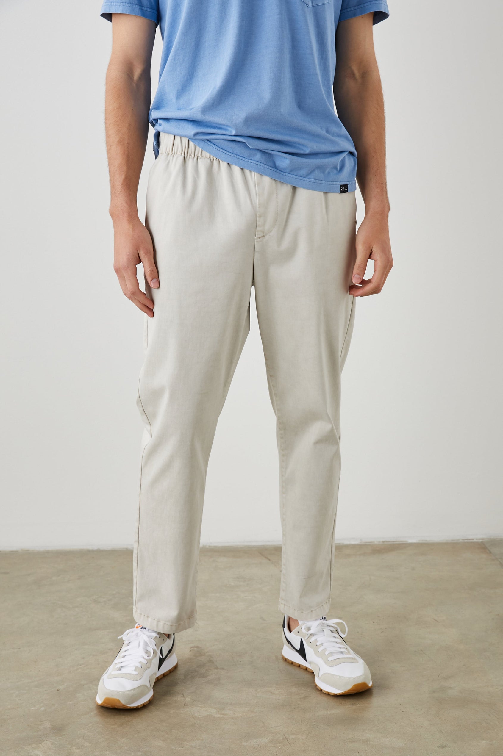 Julian Pants with an Elastic Waist, Two Front Pockets and Two Back Welt Pockets in Natural Colorway - Front View Featured on Model
