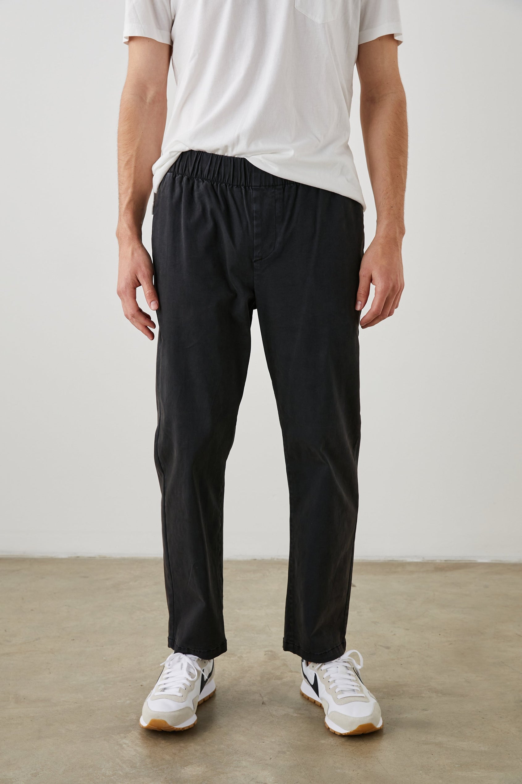 Julian Pants with an Elastic Waist, Two Front Pockets and Two Back Welt Pockets in Washed Black Colorway - Front View Featured on Model