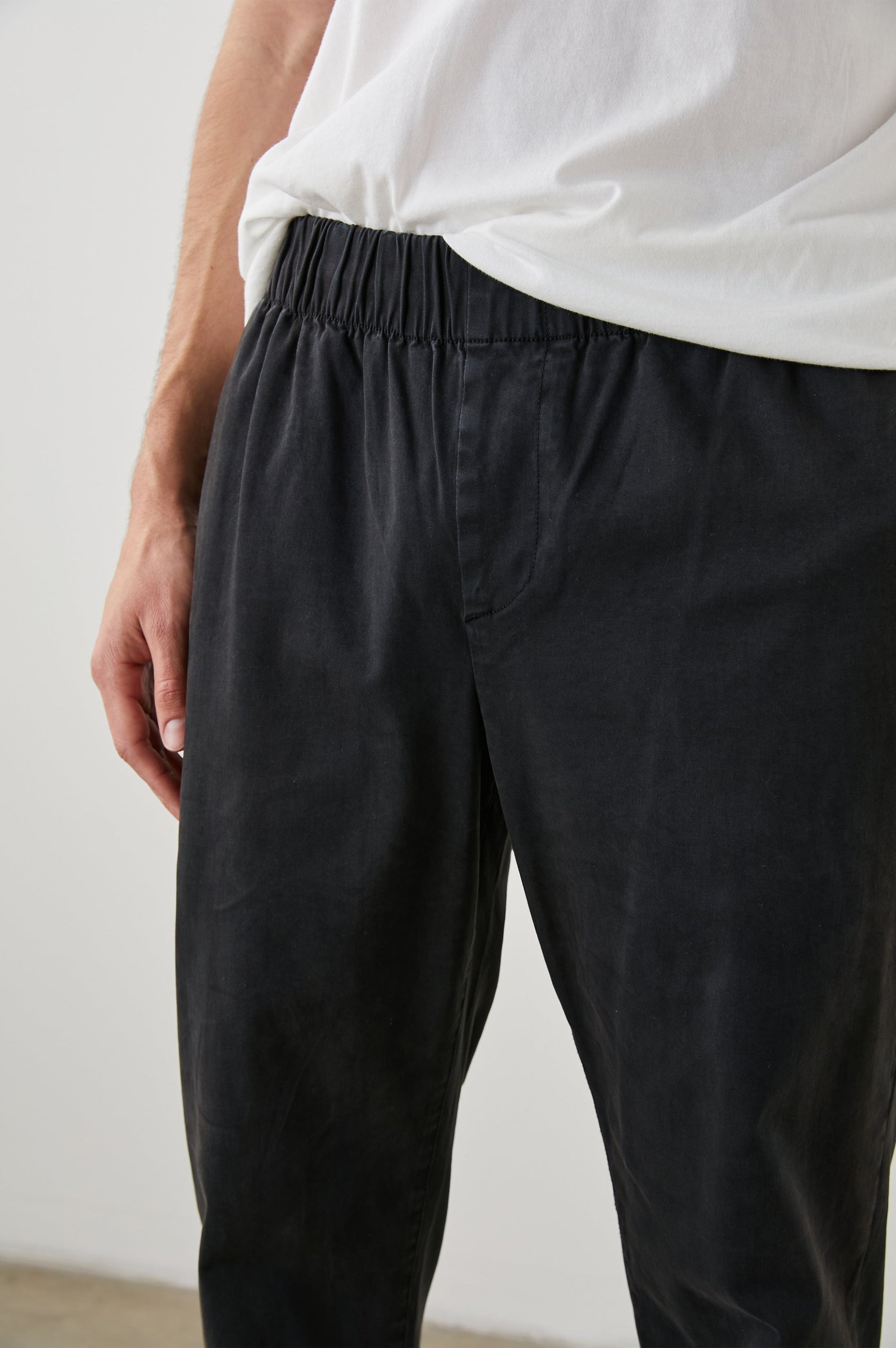 Julian Pants with an Elastic Waist, Two Front Pockets and Two Back Welt Pockets in Washed Black Colorway - Front View Featured on Model
