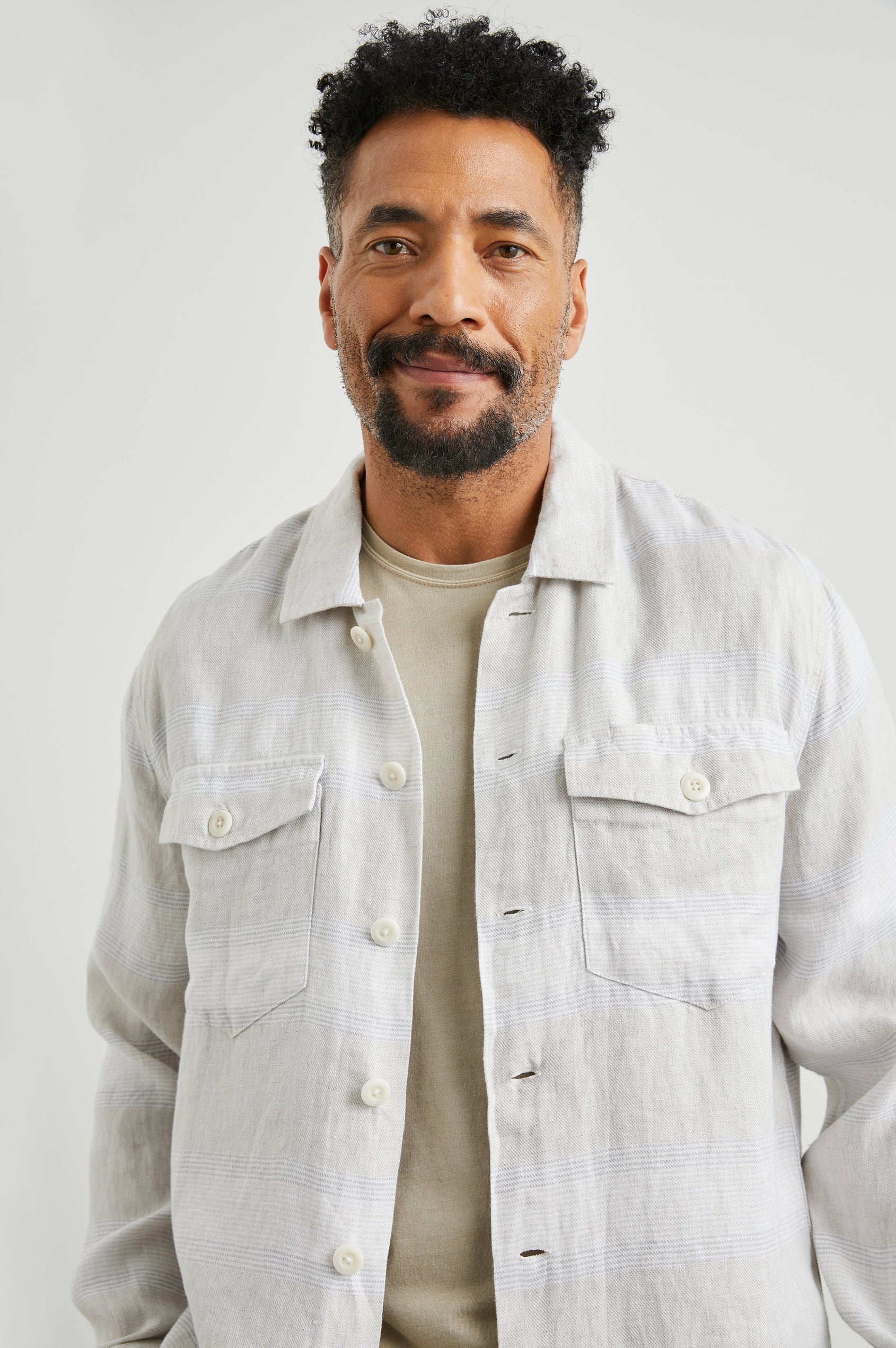 Kerouac Long-Sleeve Shirt Jacket with Button Closure and Two Button Chest Flap Pockets in Wicker Graphite Stripe Colorway, Grey and White Horizontal Stripes on Wicker - Front Unbuttoned View Featured on Model