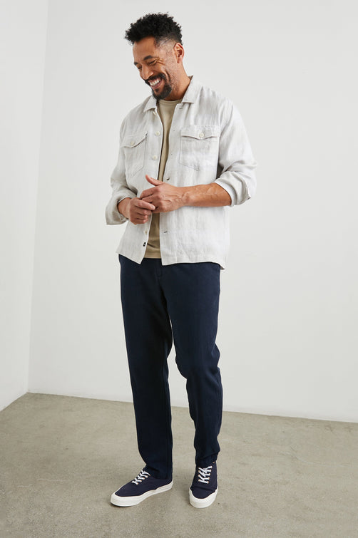 Kerouac Long-Sleeve Shirt Jacket with Button Closure and Two Button Chest Flap Pockets in Wicker Graphite Stripe Colorway, Grey and White Horizontal Stripes on Wicker - Front Unbuttoned View Featured on Model