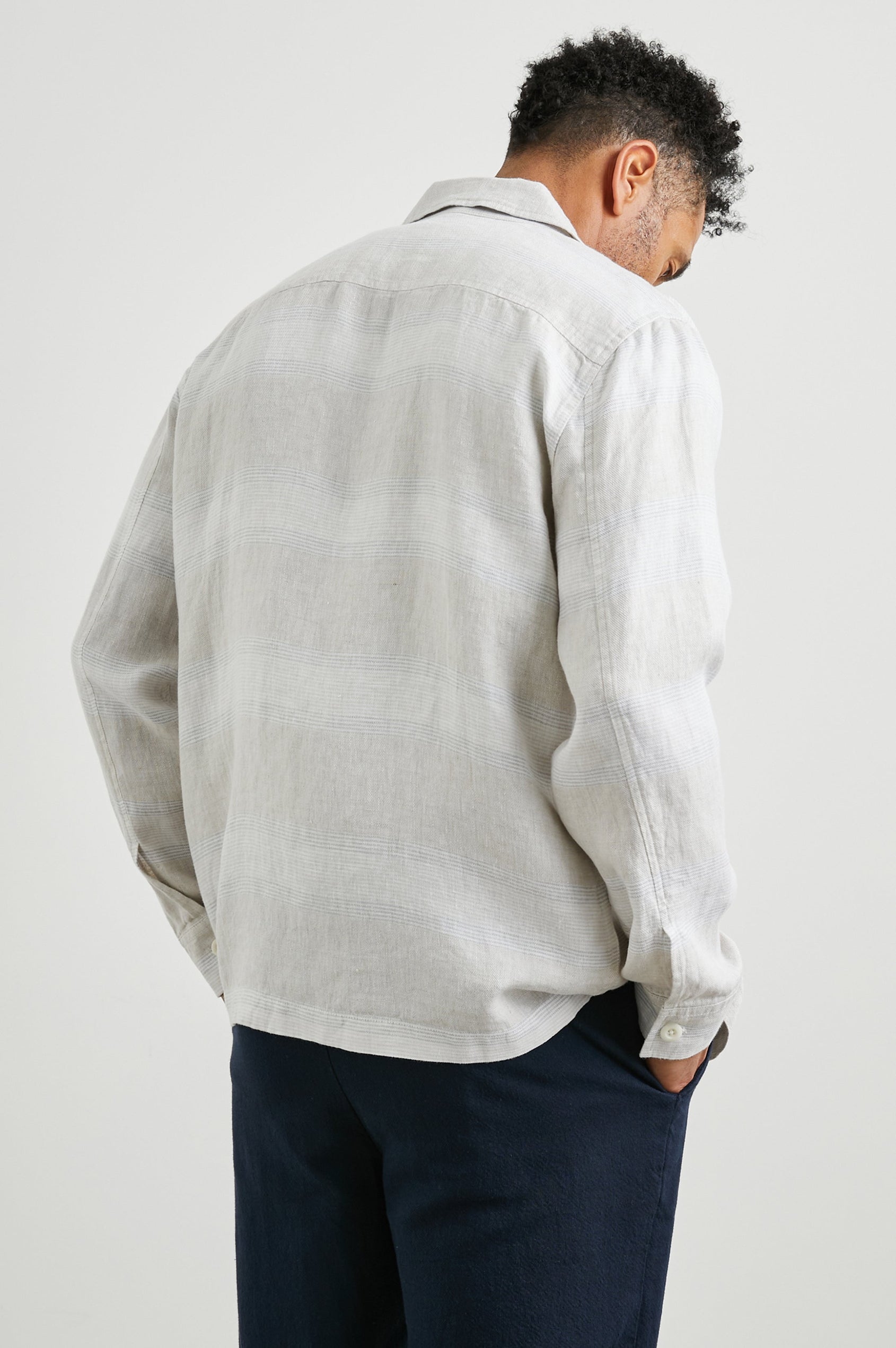Kerouac Long-Sleeve Shirt Jacket with Button Closure and Two Button Chest Flap Pockets in Wicker Graphite Stripe Colorway, Grey and White Horizontal Stripes on Wicker - Back Unbuttoned View Featured on Model