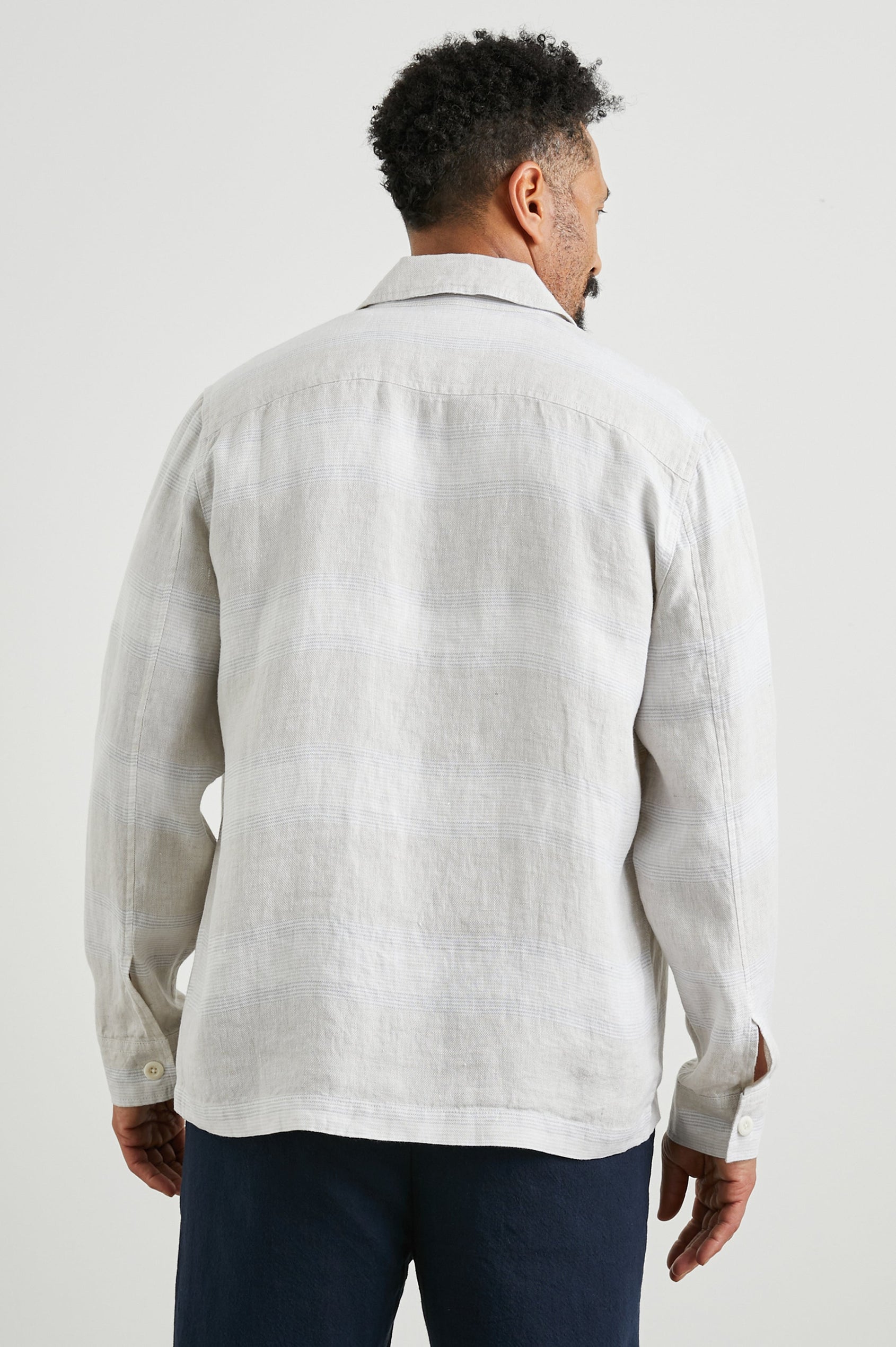 Kerouac Long-Sleeve Shirt Jacket with Button Closure and Two Button Chest Flap Pockets in Wicker Graphite Stripe Colorway, Grey and White Horizontal Stripes on Wicker - Back Unbuttoned View Featured on Model