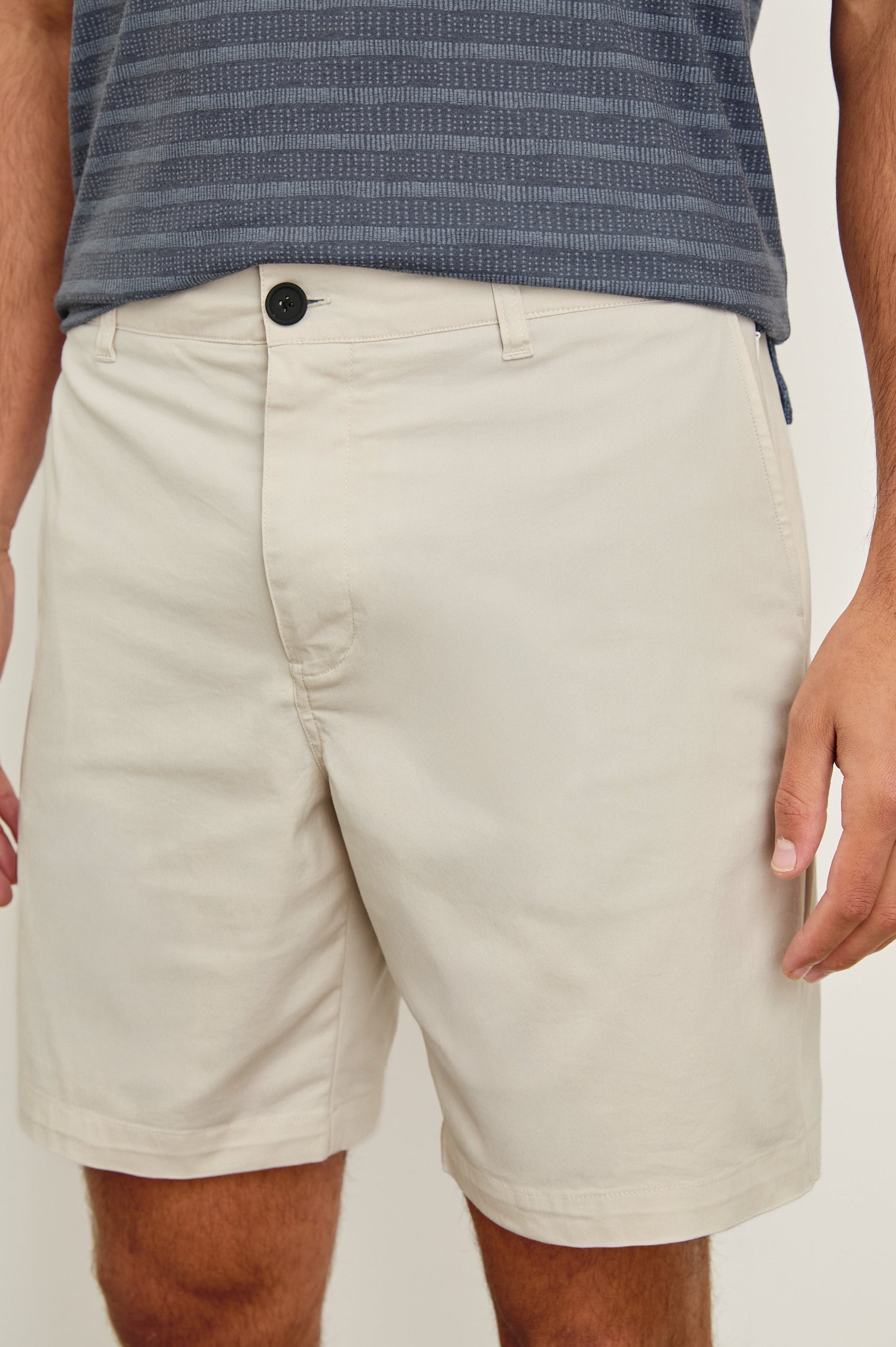 Laguna cotton lid-length short with front button closure and belt loops - close up of details on model
