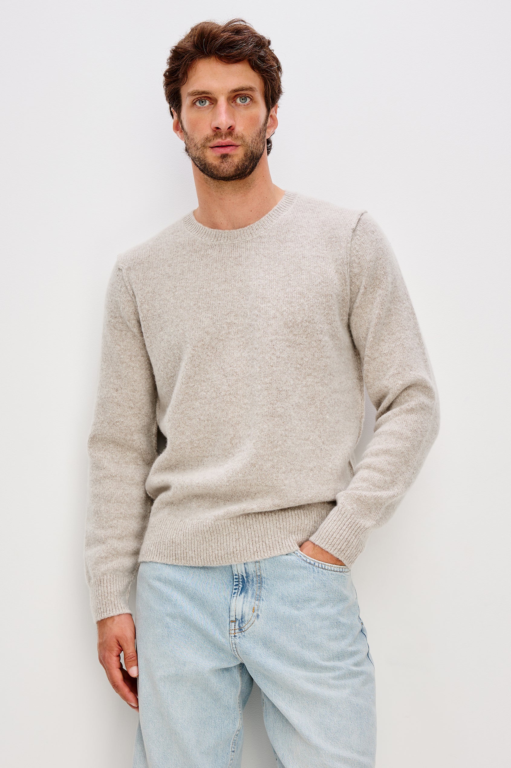 Laurent is a relaxed-fit crewneck sweater, dropped shoulders, long sleeves, and linking-stitch detailing at the shoulders in Silverleaf colorway. Front view featured on model.