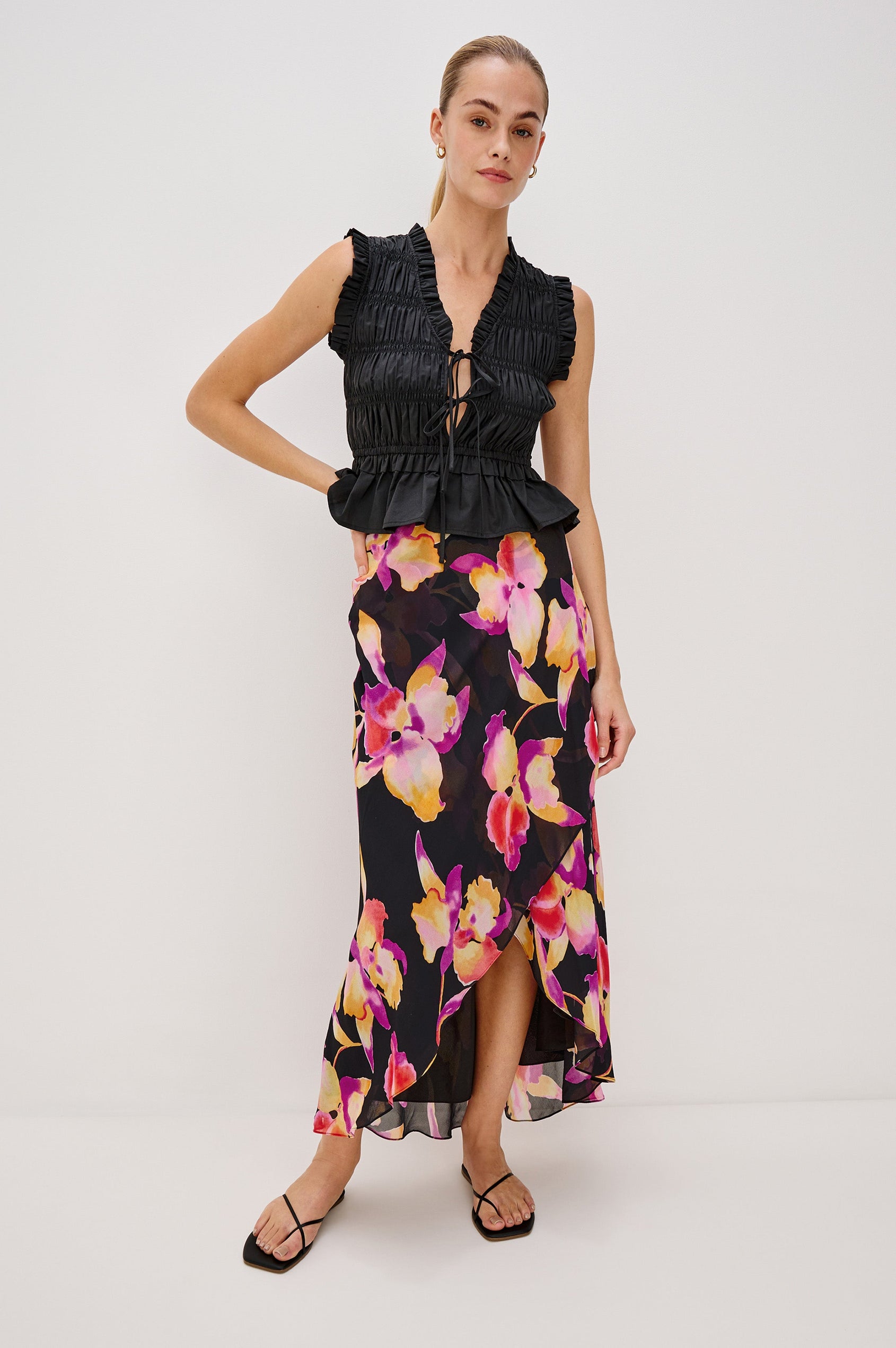 Lenora Cross Front Skirt, High-Low Midi Length, Hidden Elastic Waistband, Lined, in Dusk Orchid Colorway. Full Body Front View Shown on Model.
