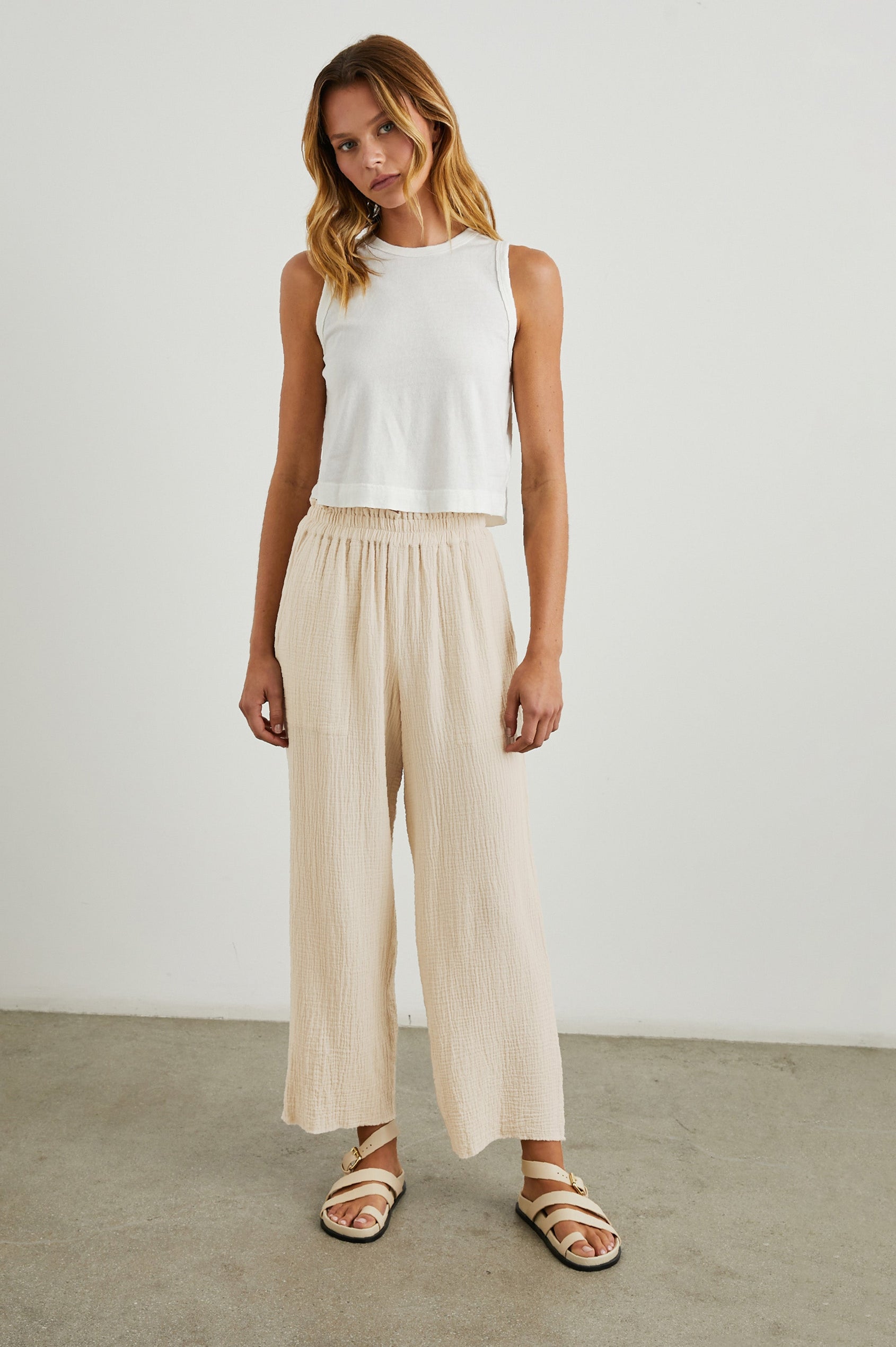 Leon Crop Pant with a Smocked Waistband and Two Front Seam Pockets in Flax Colorway - Front Full Body View Featured on Model