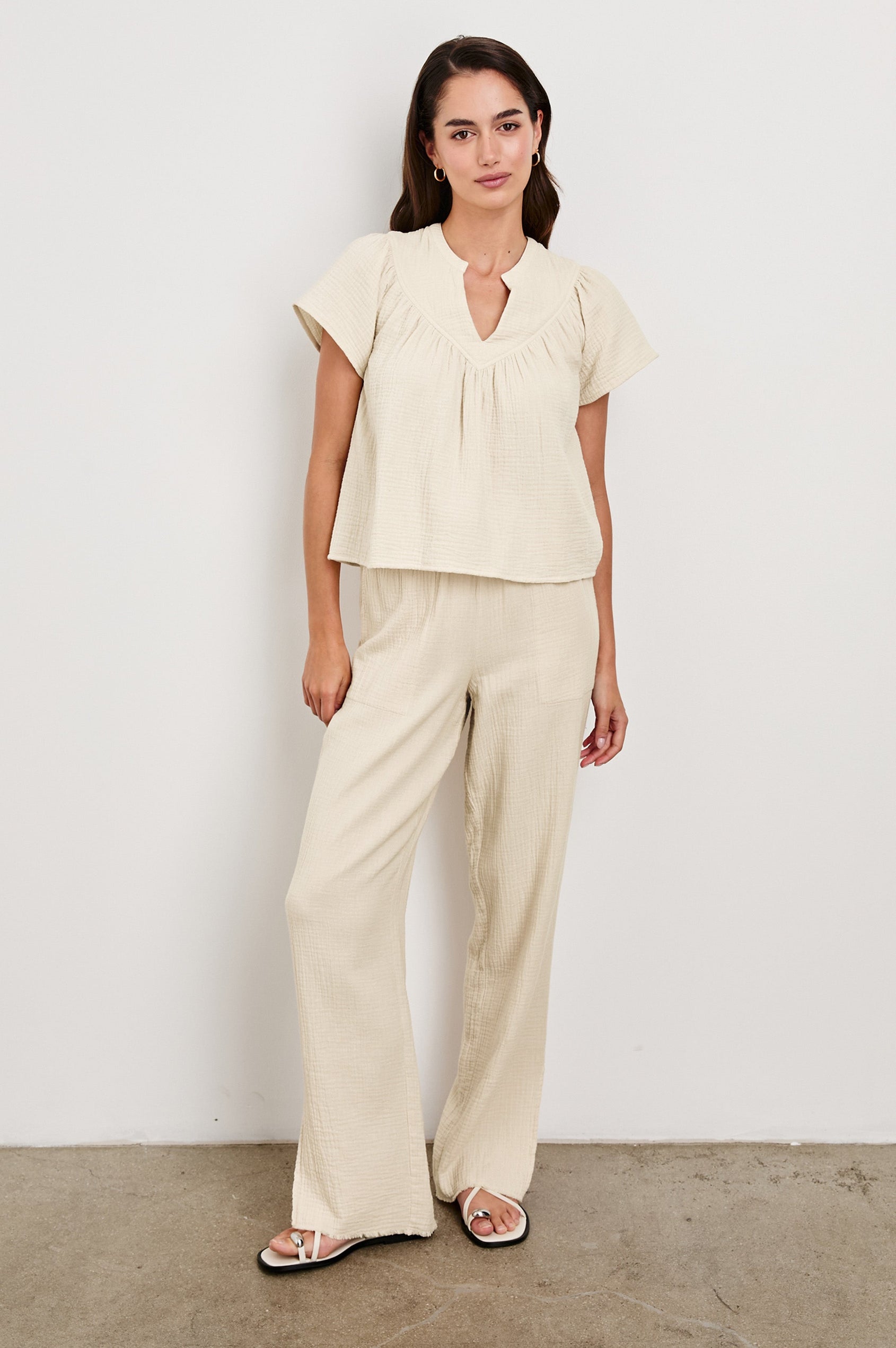 Leon Cotton Gauze Pant With Hemline Slit And Elastic Waist In Colorway Flax - Full Front Body View Featured On Model