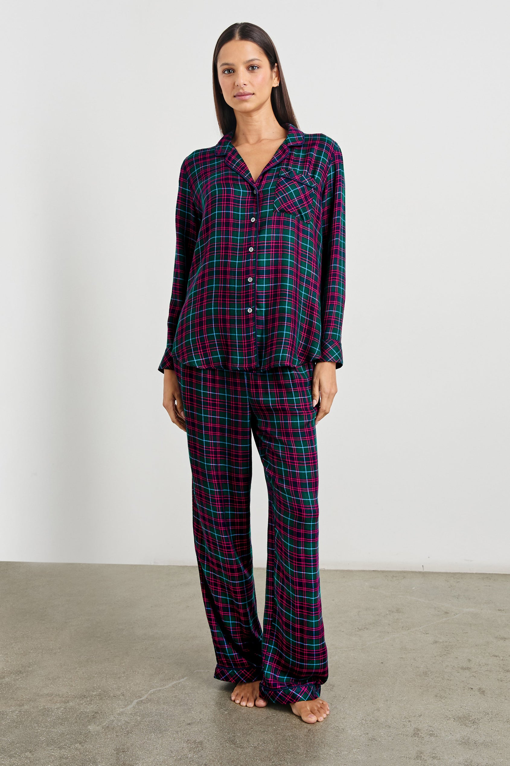 Luna Pajama Set with a Long Sleeve, Button Up, V Neck Top with a Chest Patch Pocket and Pants with Two Front Pockets in Evergreen Fuchsia Ice Colorway, a plaid - Front Full Body View Featured on Model