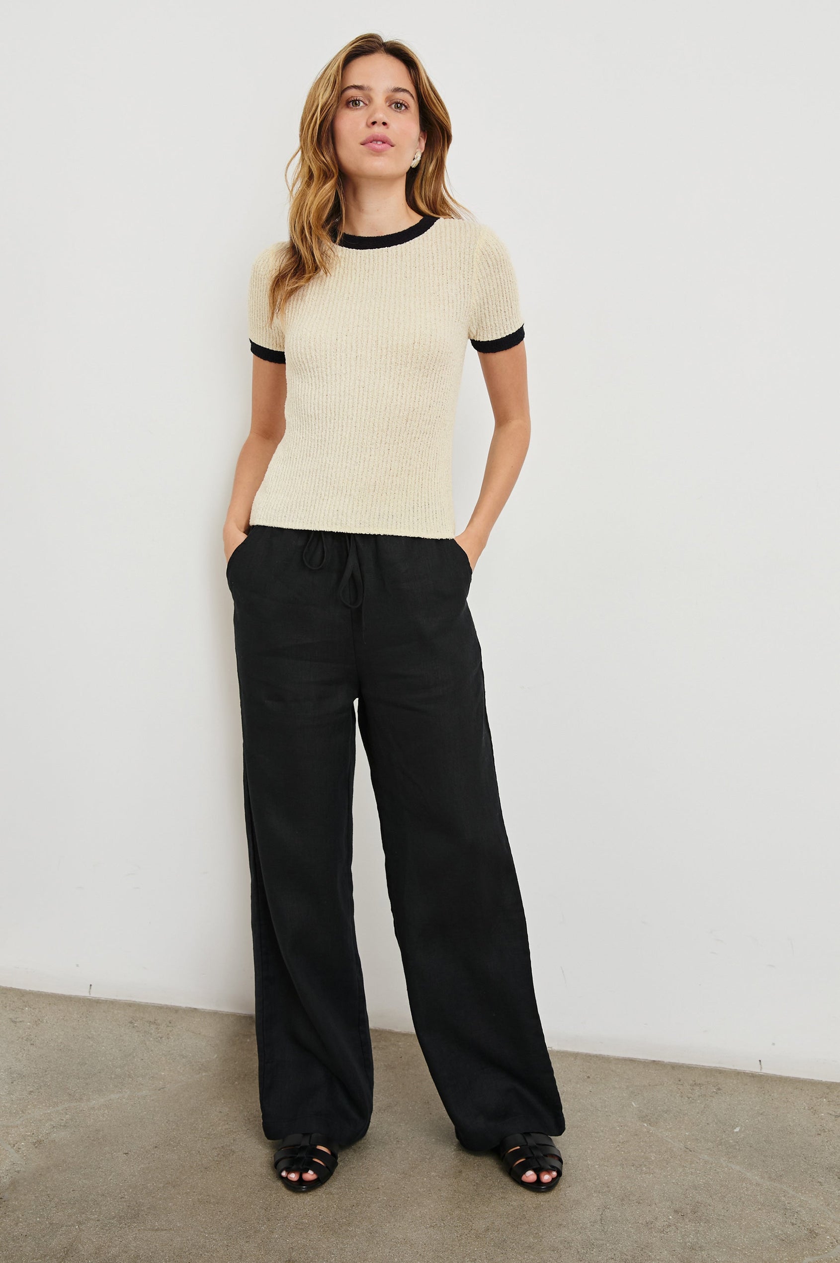 Meredith Short-Sleeve Ribbed Top with Crew Neckline in Ivory Black Colorway, with Black trim at the Neckline and Cuffs - Front Full Body View Featured on Model