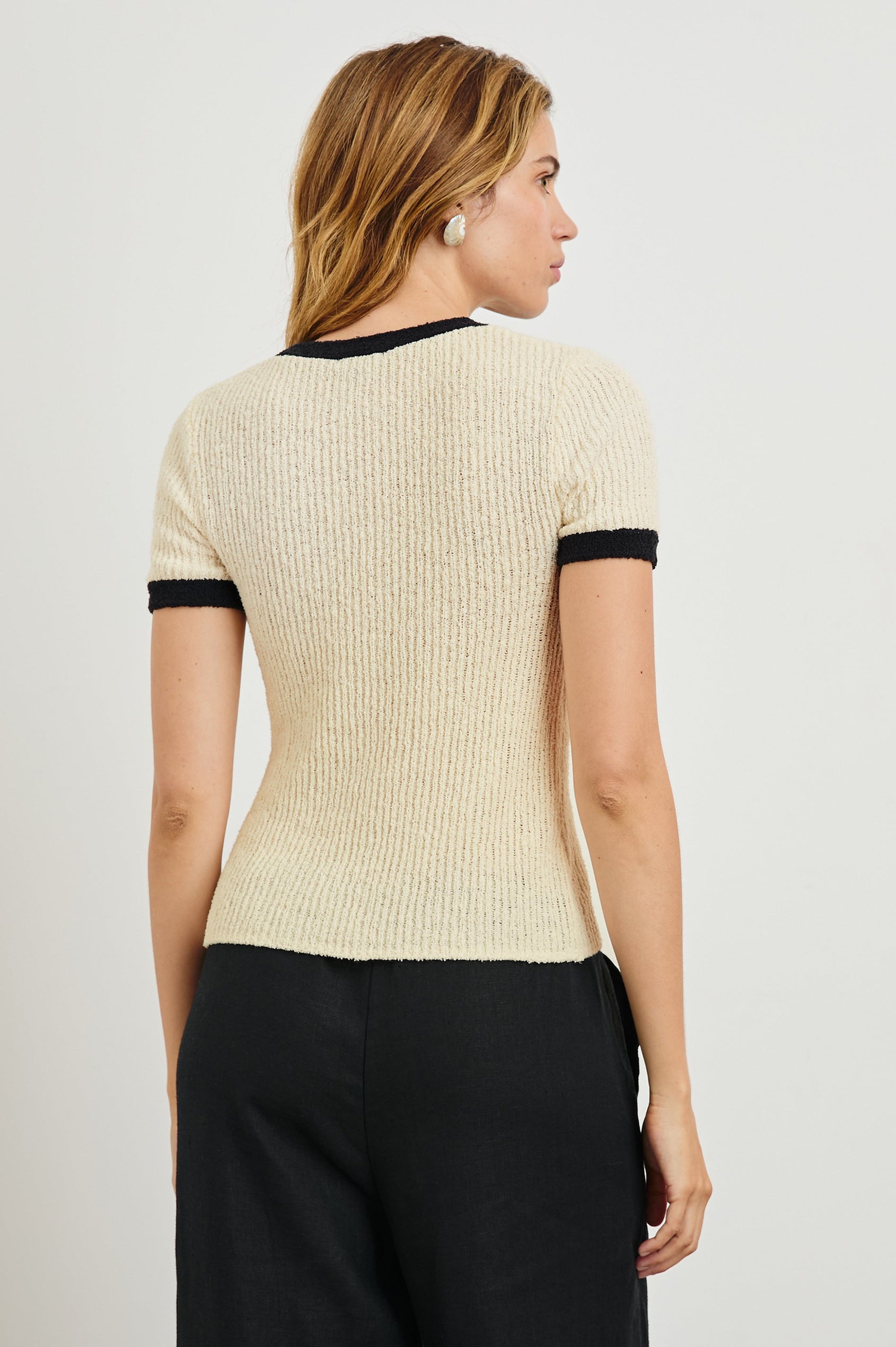 Meredith Short-Sleeve Ribbed Top with Crew Neckline in Ivory Black Colorway, with Black trim at the Neckline and Cuffs - Back View Featured on Model