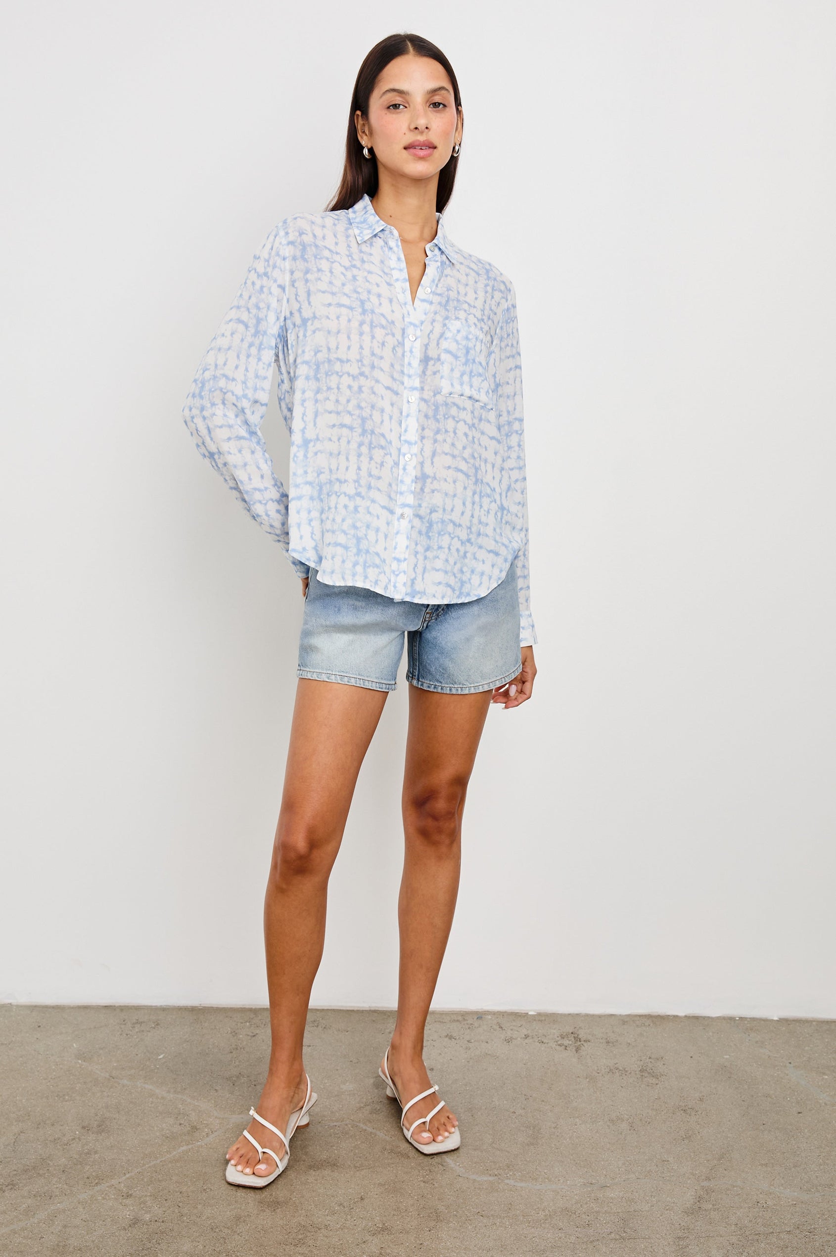 Mesa Denim Shorts with a Raw Hem, Button Fly, Belt Loops, Two Front Pockets and Two Back Patch Pockets in Lakeside Colorway - Front Full Body View Featured on Model