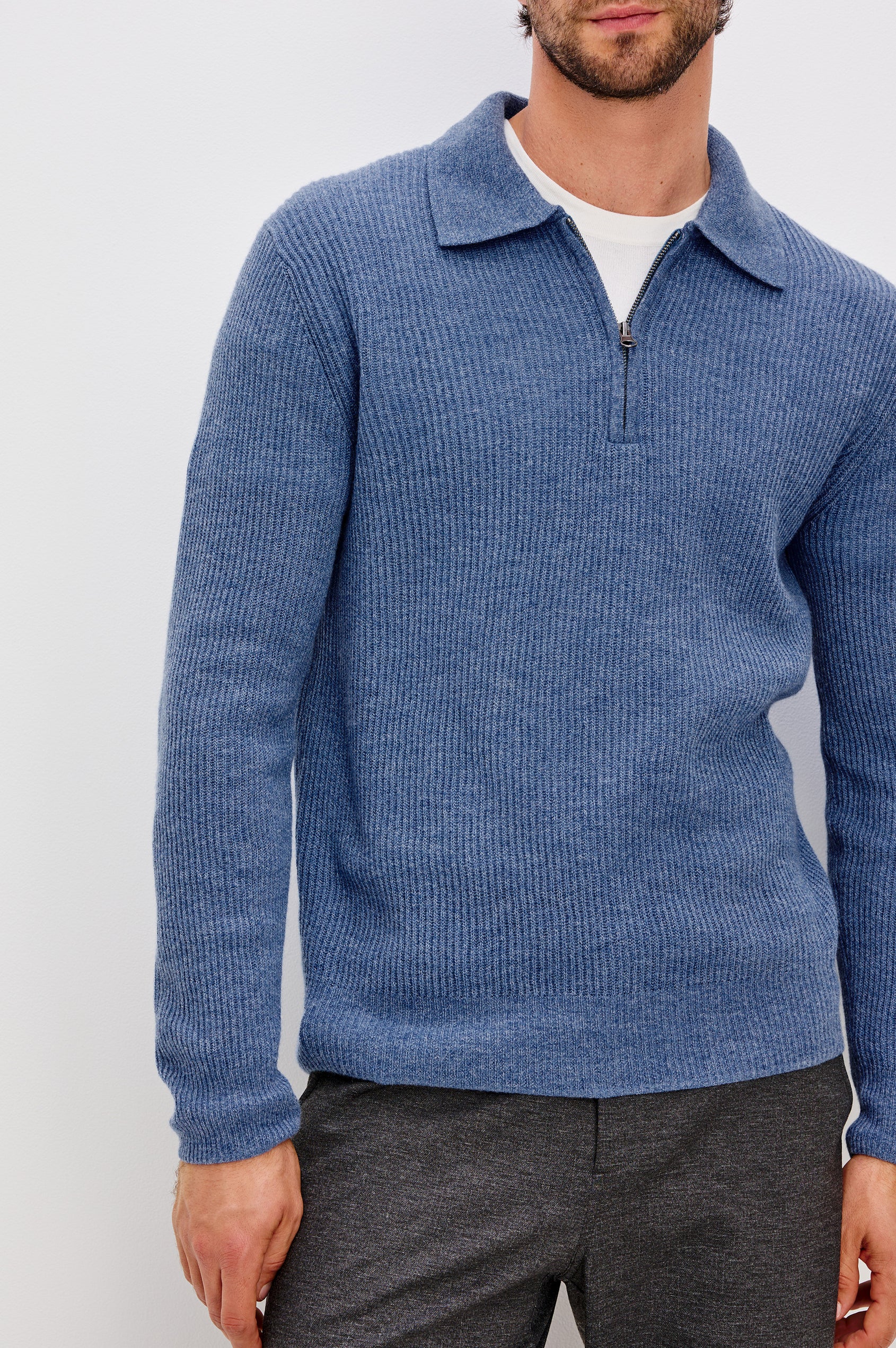 Monty is a collared quarter-zip long sleeved sweater in Cerulean Melange colorway. Front detail view featured on model.