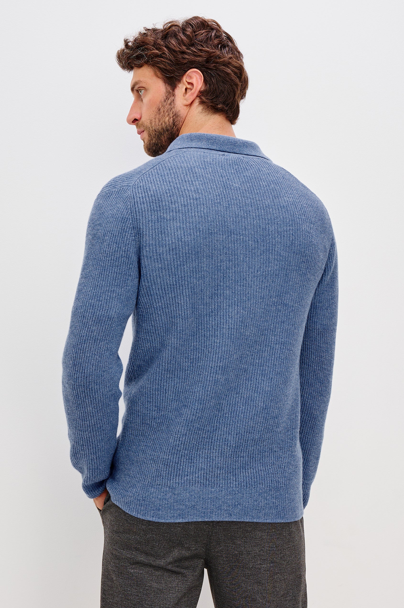 Monty is a collared quarter-zip long sleeved sweater in Cerulean Melange colorway. Back view featured on model.