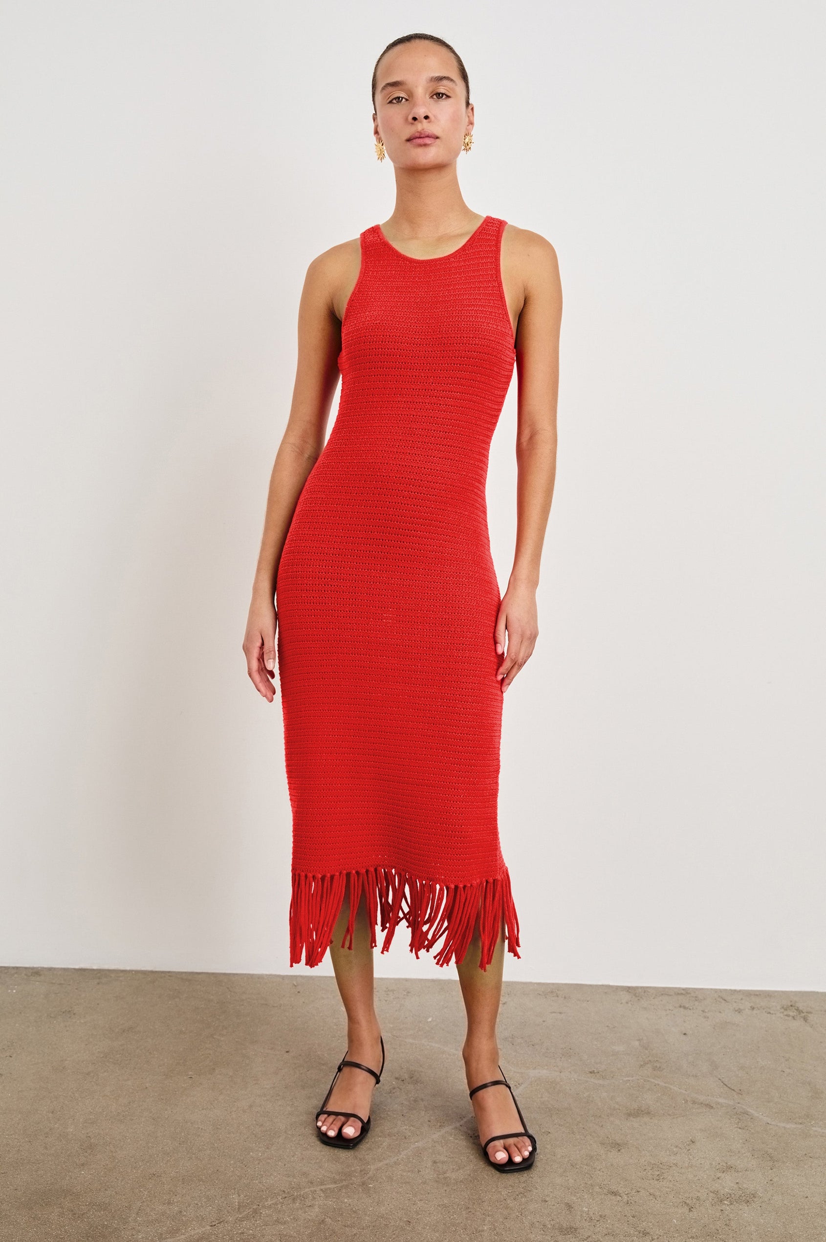 Front view of female model wearing our sleeveless, Nia Midi Dress in color Cherry, featuring crochet structure and fringe details at the hem.