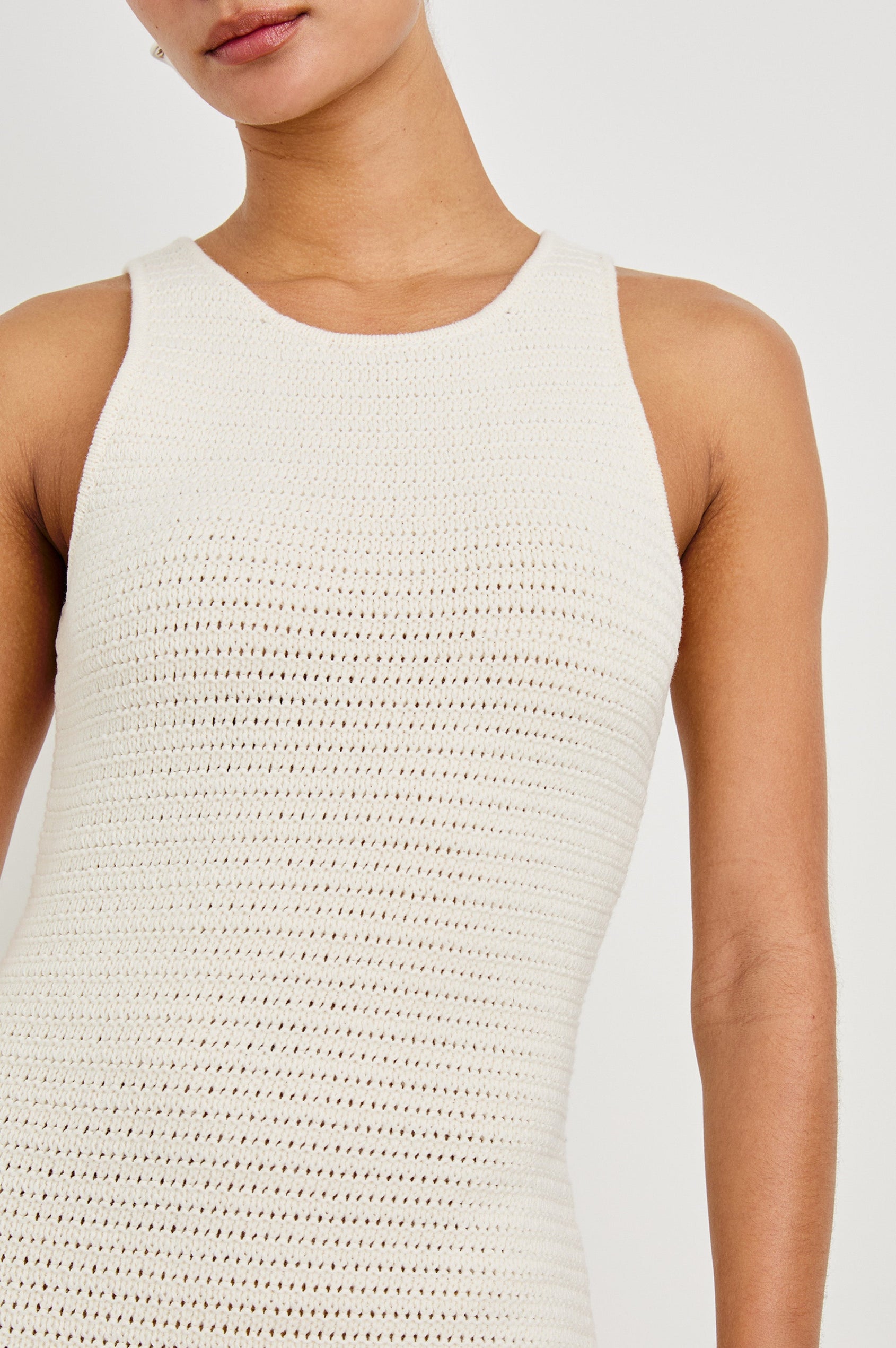 Close up detail shot of female model wearing our sleeveless, Nia Midi Dress in color Ecru, featuring crochet structure and thick straps.