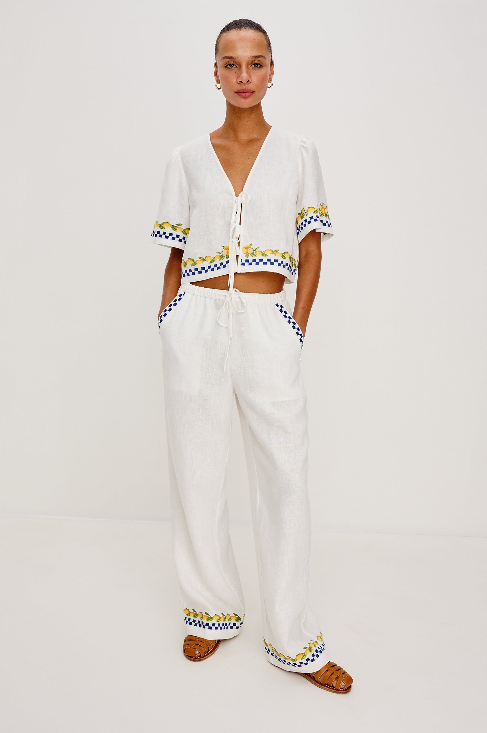 Pari linen top in Sorrento Embroidery colorway. Featuring front tie closures and Italian inspired embroidery - Full body front view on model