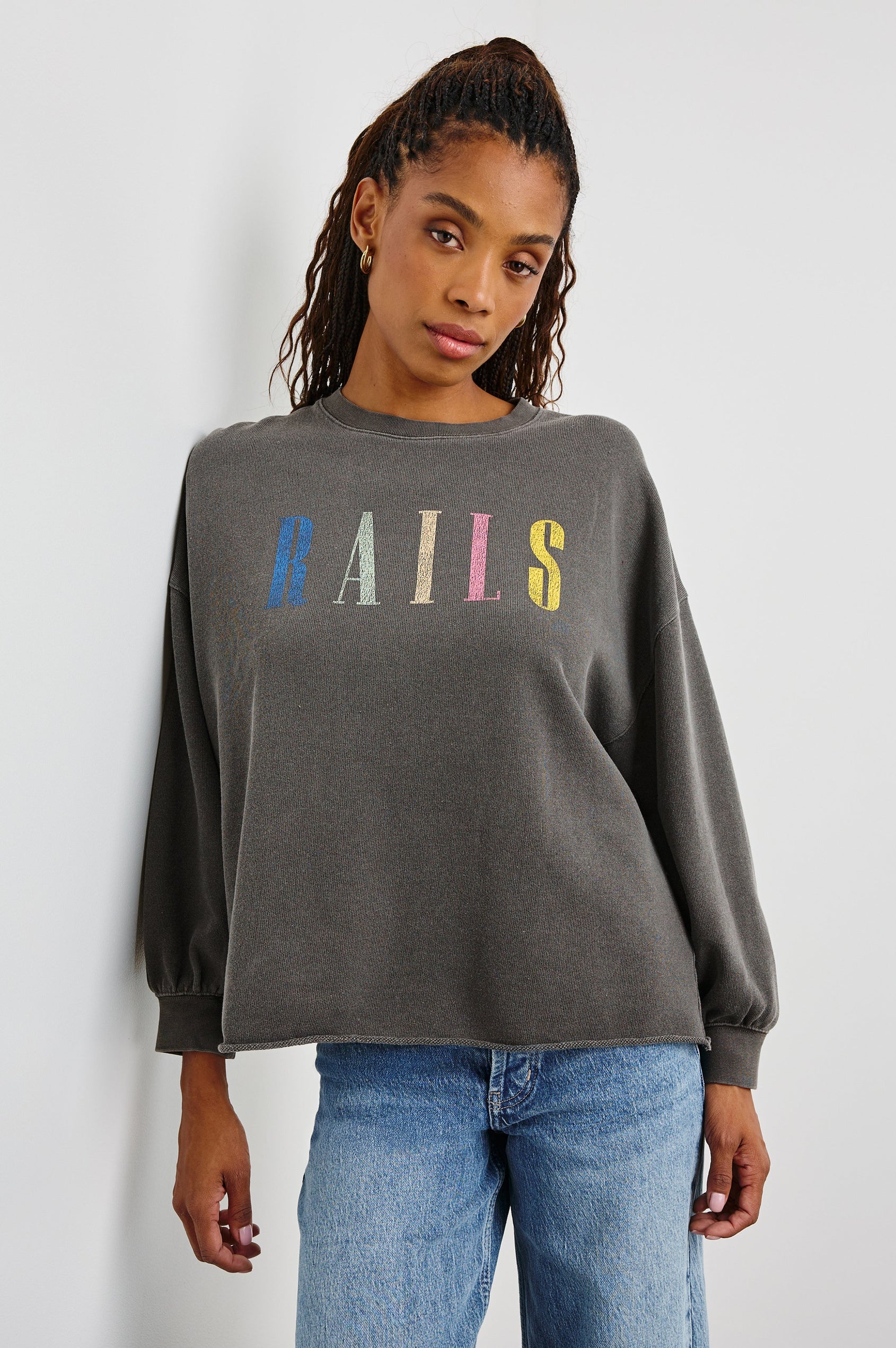 Rails Signature Long-Sleeve Sweatshirt with a Crew Neck, Raw Hem, Shirring Above Cuff, and the Text, Rails, in Vintage Black Colorway, with Multi Colored Text - Front View Featured on Model